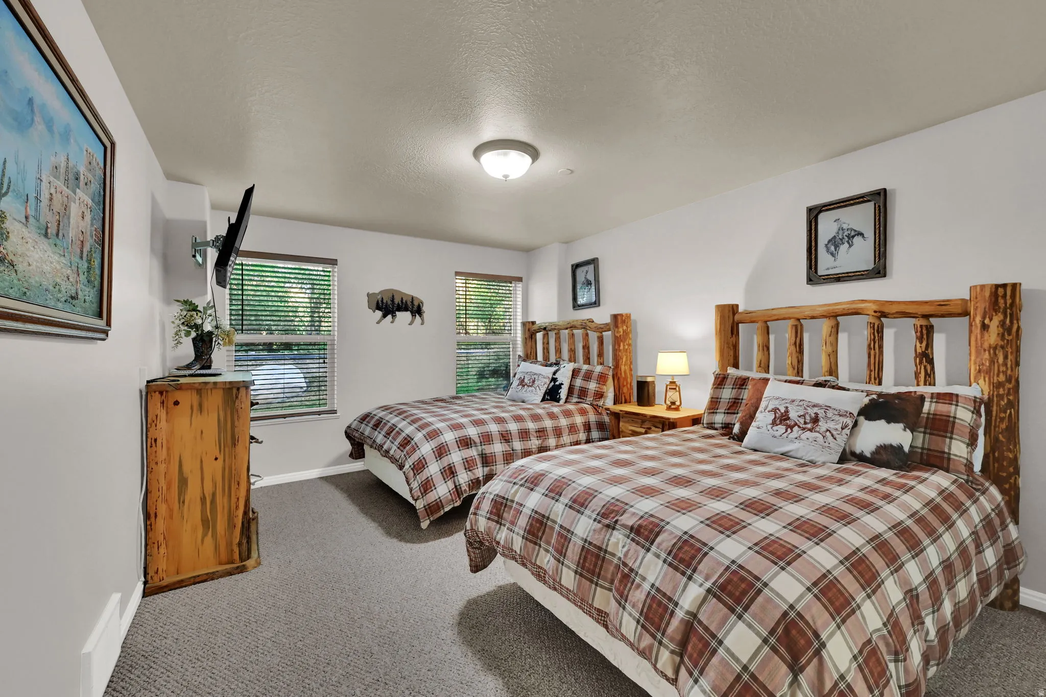 Carpeted bedroom with a textured ceiling and baseboards