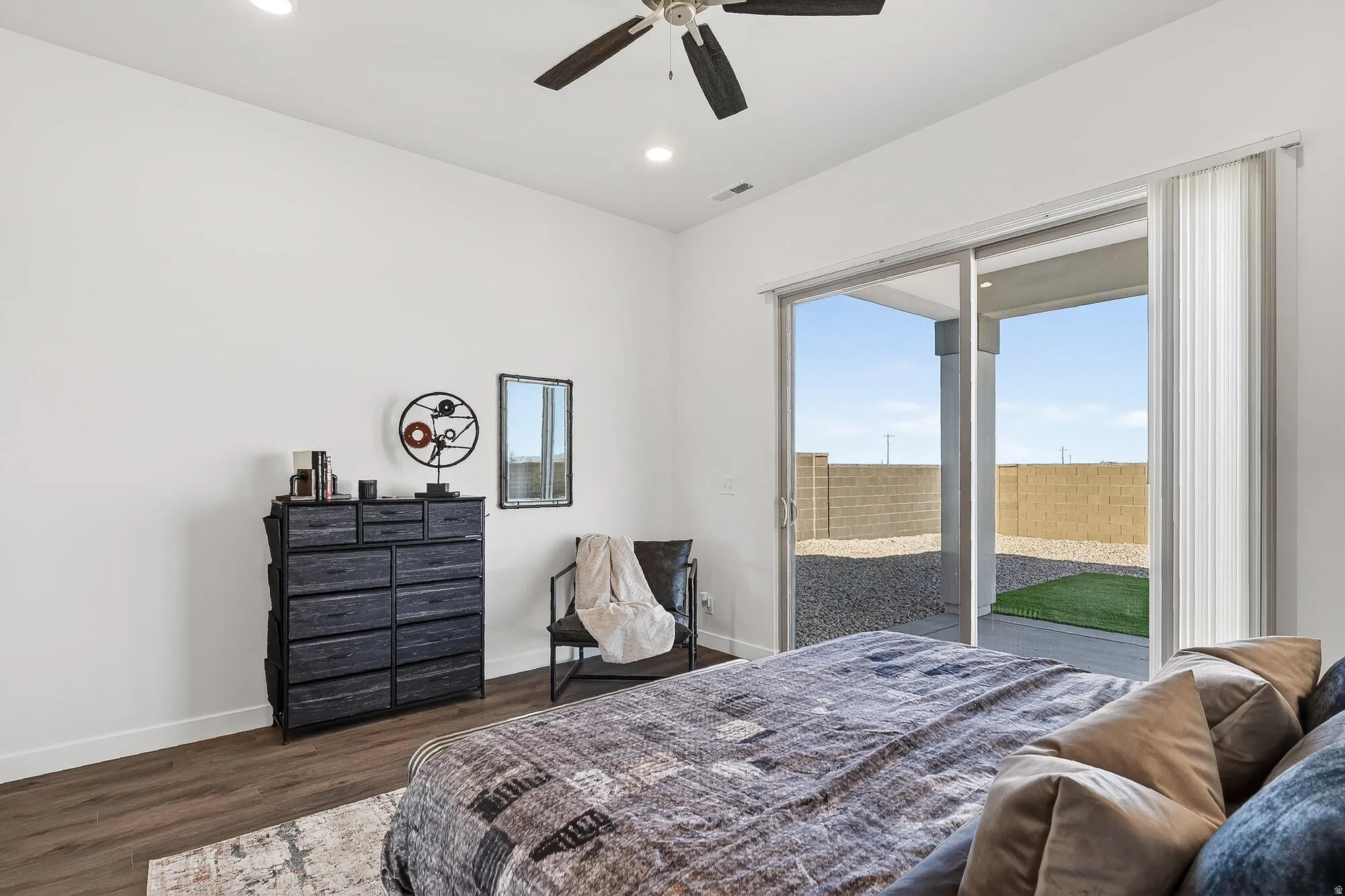 Bedroom with dark wood finished floors, recessed lighting, ceiling fan, and access to outside