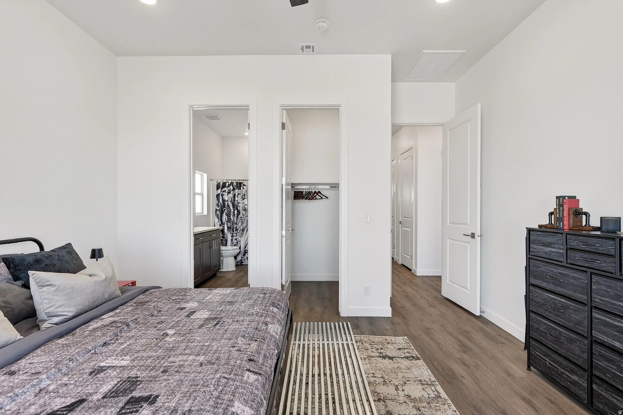 Bedroom featuring a closet, dark wood finished floors, ensuite bath, and recessed lighting