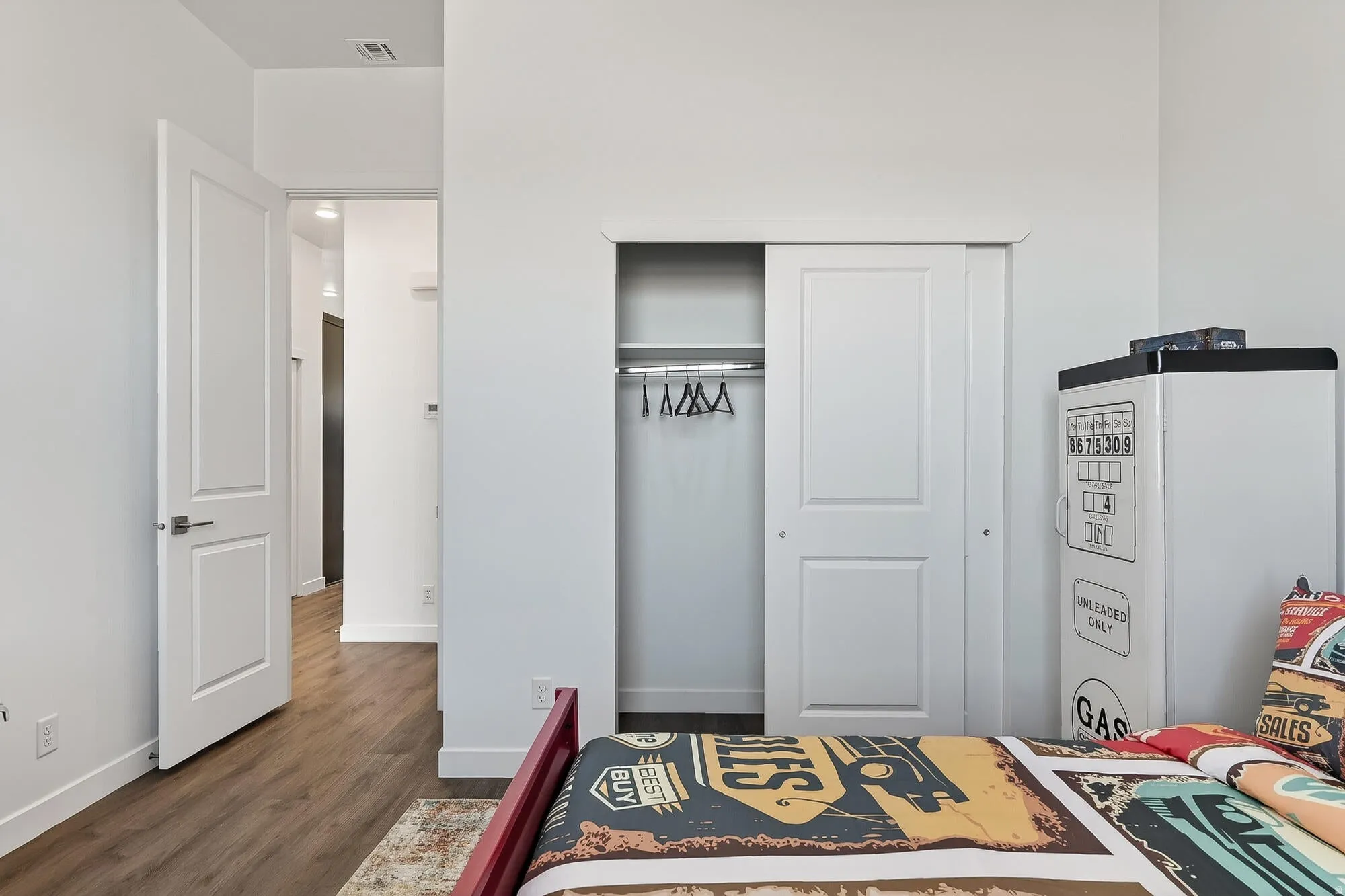 Bedroom with a closet and dark wood-type flooring
