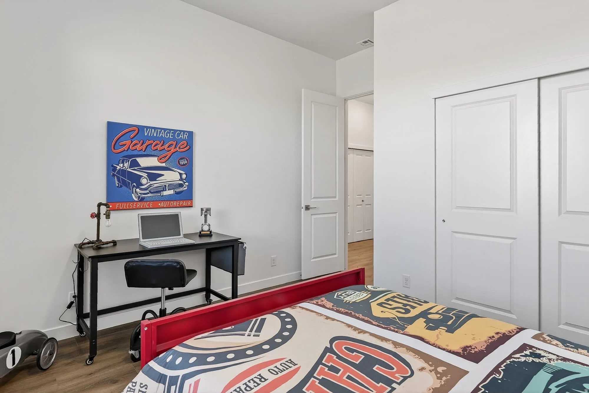 Bedroom featuring wood finished floors and a closet