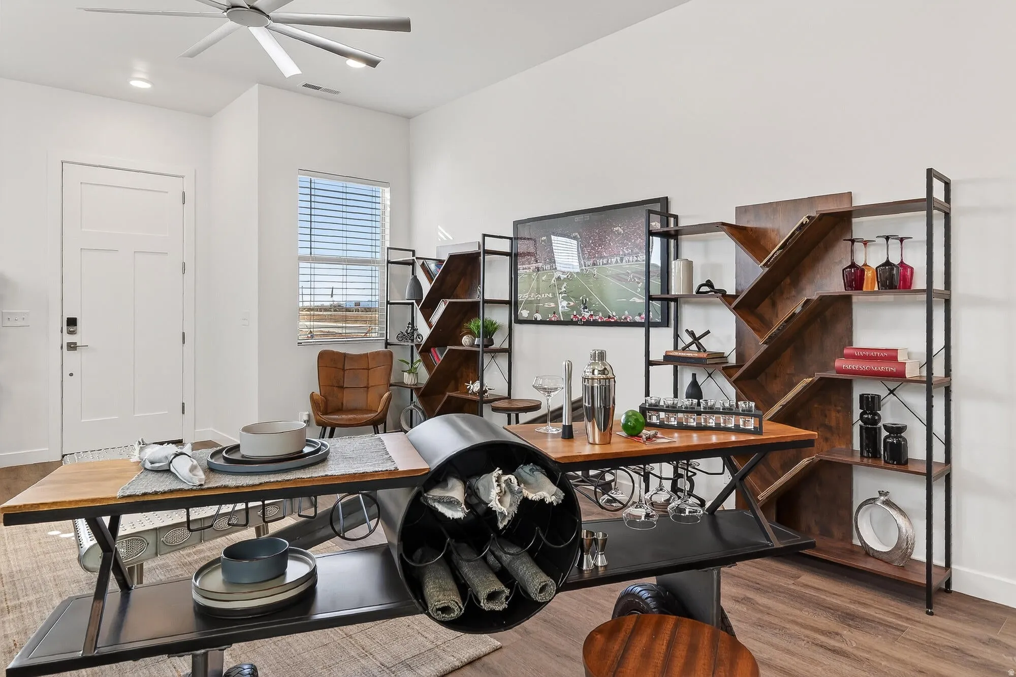 Office space with light wood-style flooring and a ceiling fan