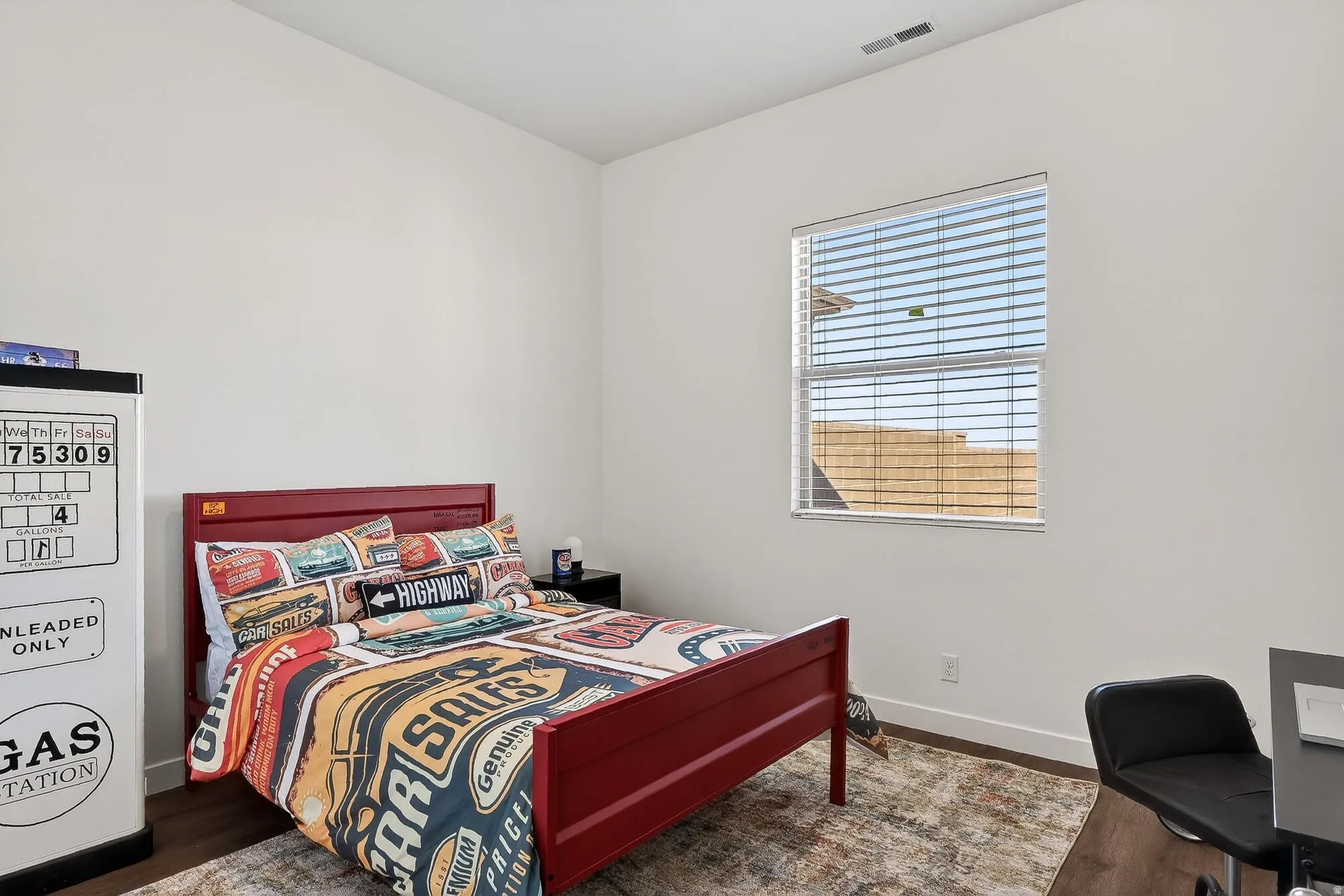 Bedroom featuring dark wood-type flooring and baseboards