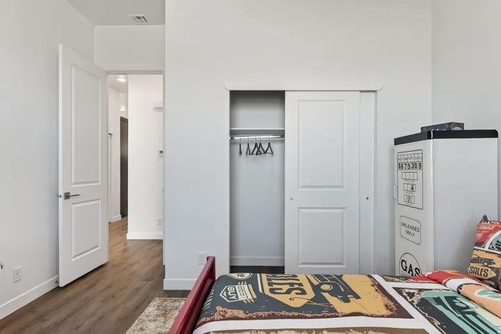 Bedroom with a closet and dark wood-type flooring