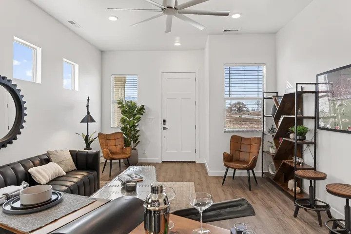 Living room featuring a ceiling fan, light wood-style flooring, and recessed lighting