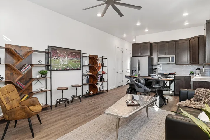 Living room with ceiling fan, light wood-style floors, and recessed lighting