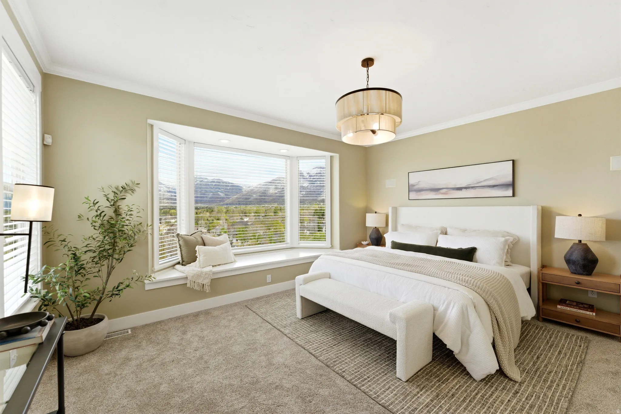 Bedroom with light carpet, ornamental molding, and a mountain view