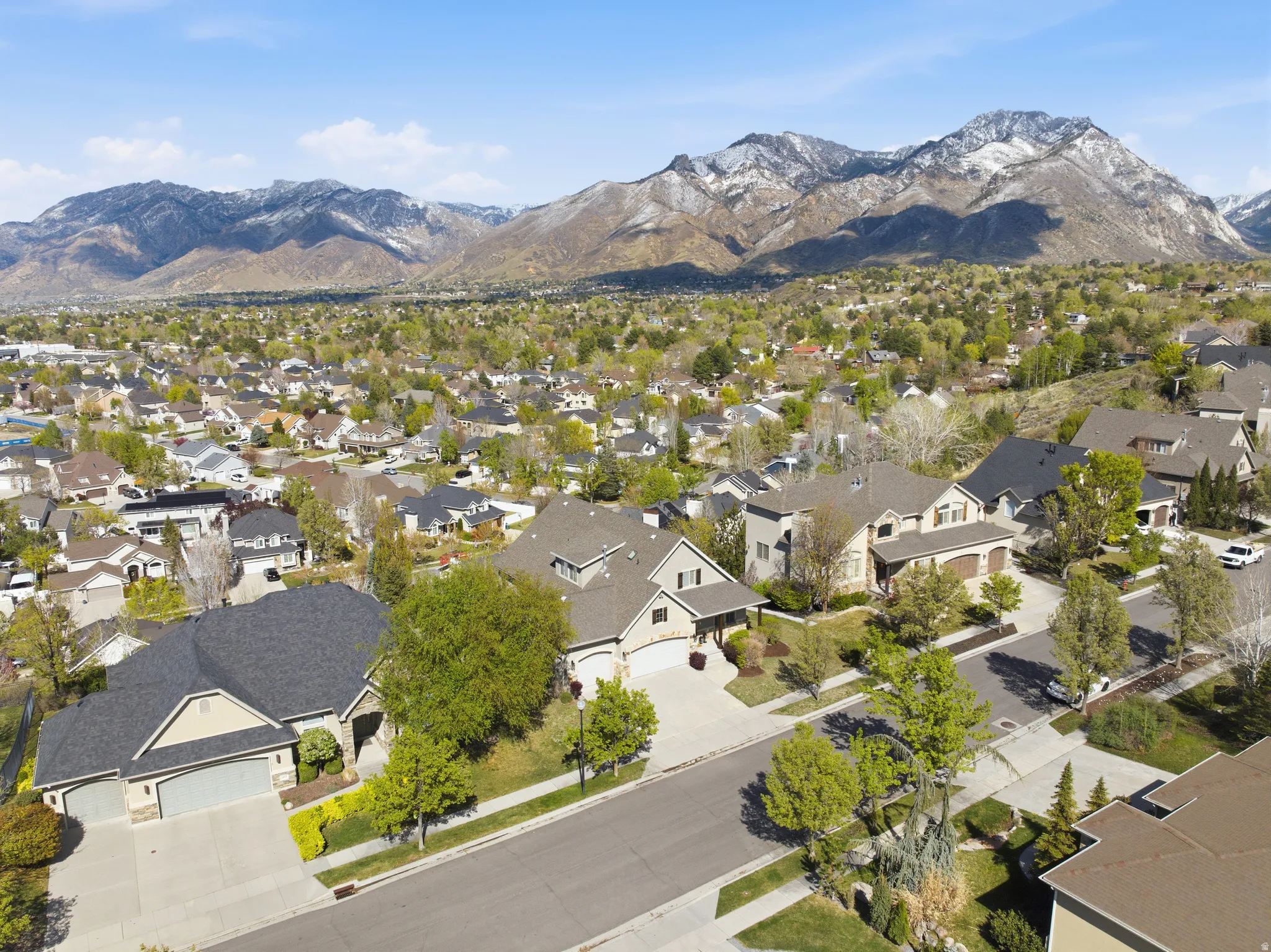 Aerial view of residential area featuring a mountainous background