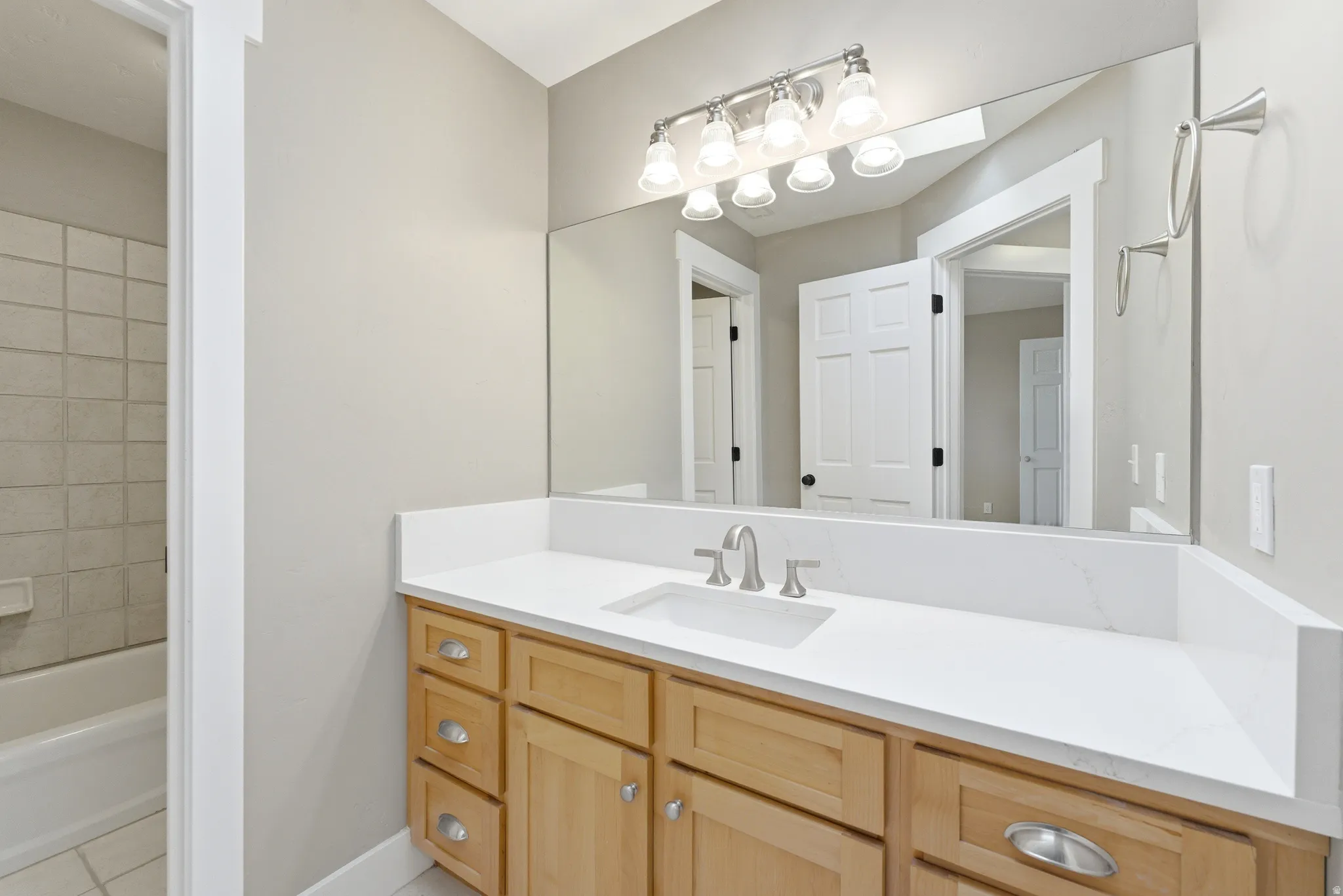 Bathroom featuring vanity, shower / bathtub combination.