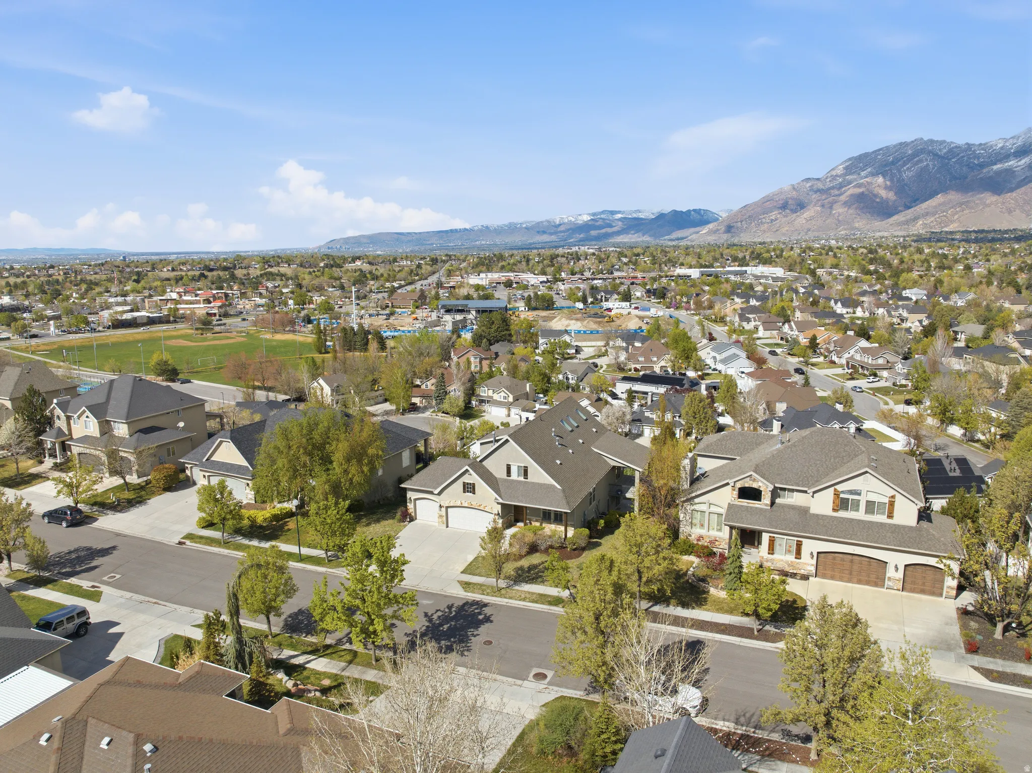 Aerial view of residential area featuring a mountainous background