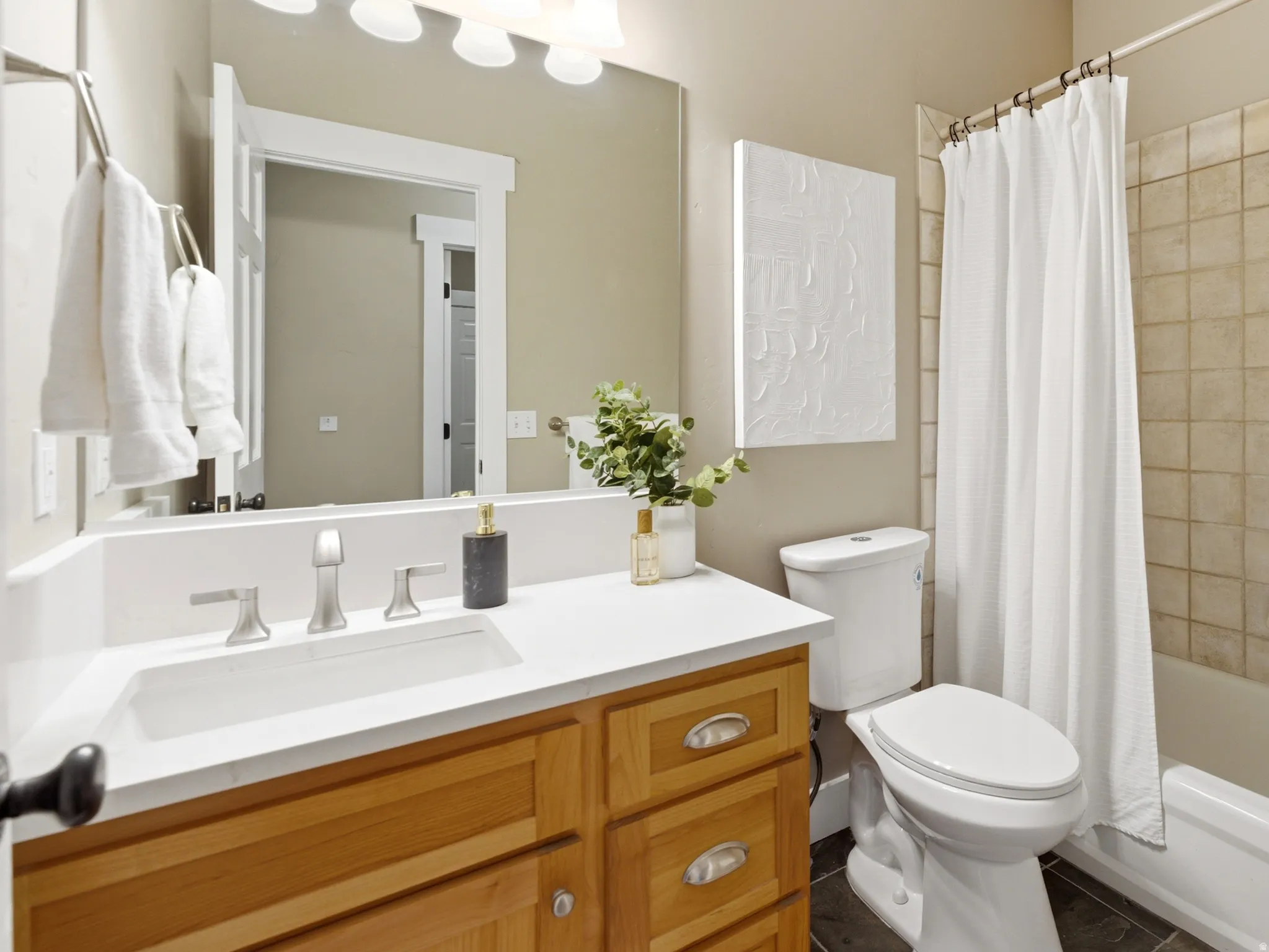 Bathroom with new countertops, faucet, and toilet.