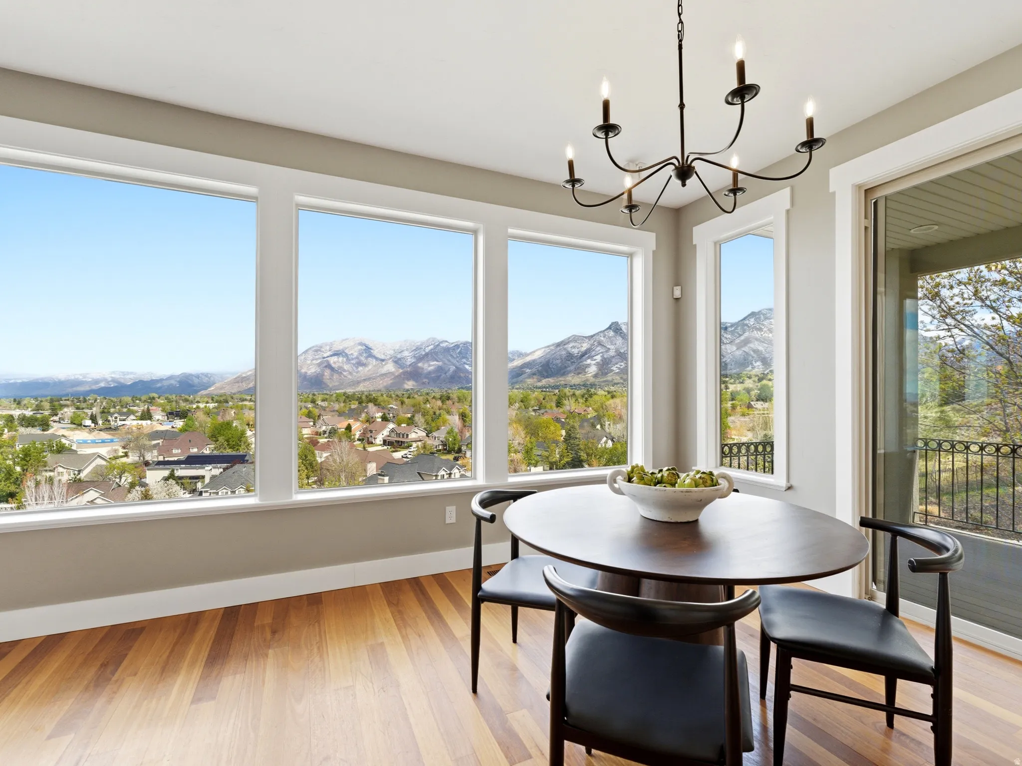 Dining space featuring light wood-type flooring, a mountain view, and suspended lighting