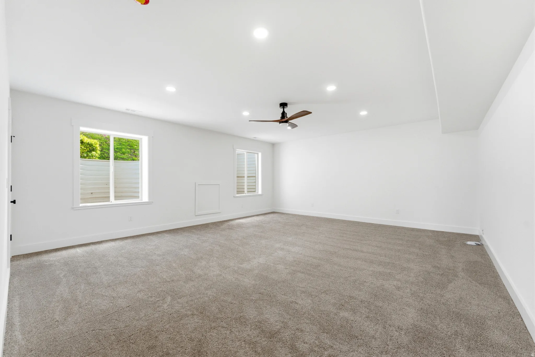 Large bedroom, big enough to be a recreation or movie room.with carpet flooring, ceiling fan, and recessed lighting
