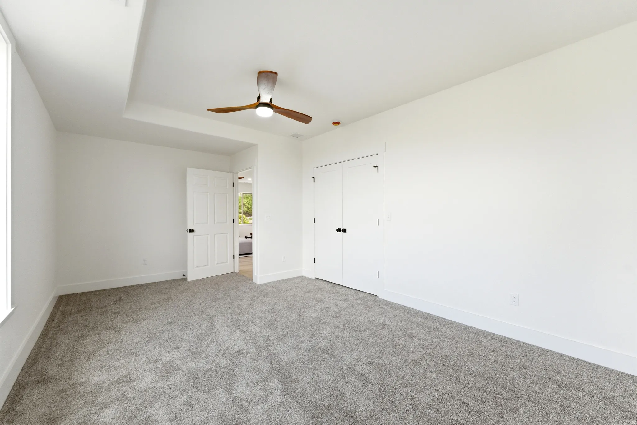 bedroom with light carpet, a closet with French doors, and ceiling fan