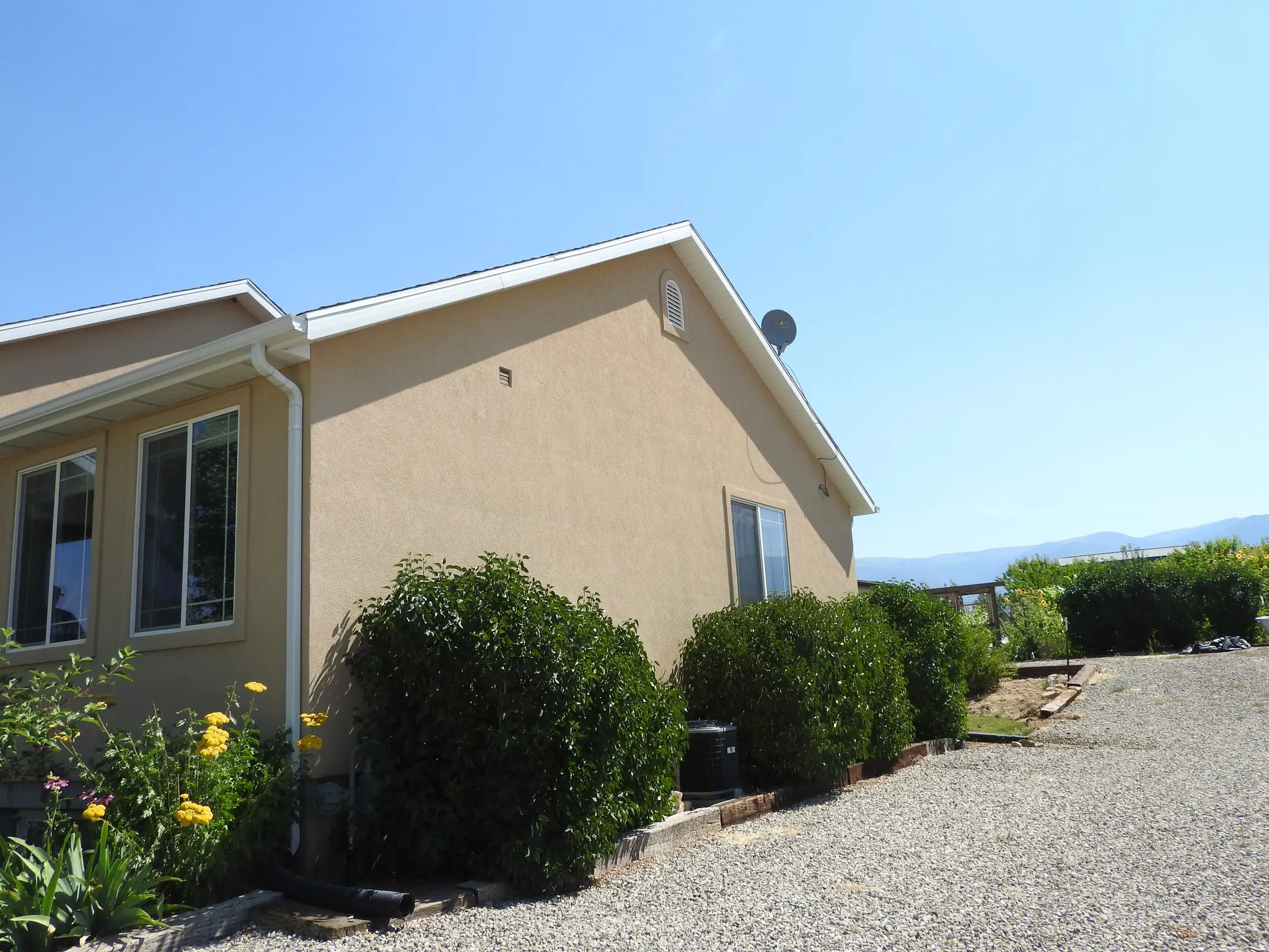 View of home's exterior with stucco siding and a mountain view