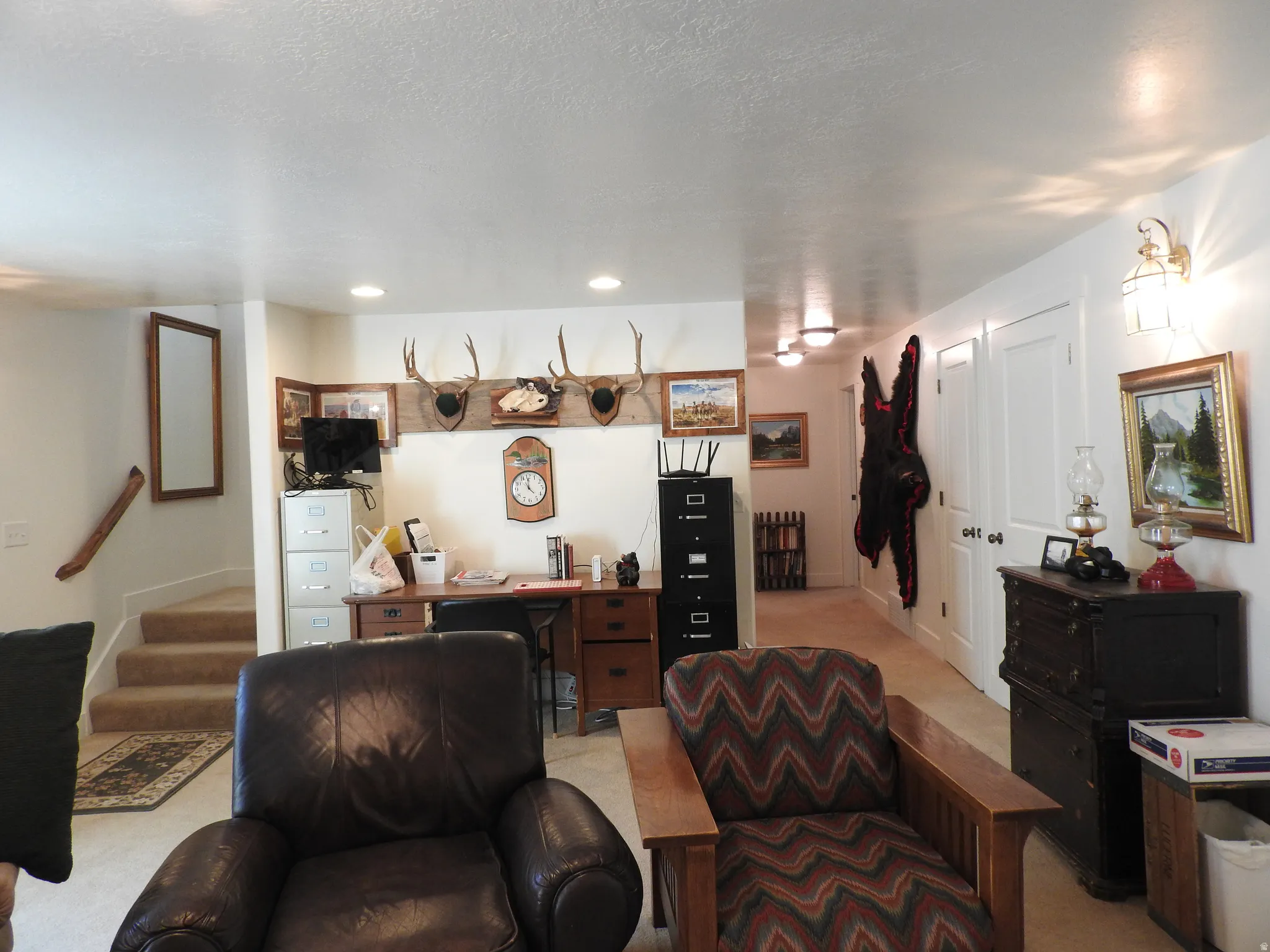 Living area with stairs and light carpet