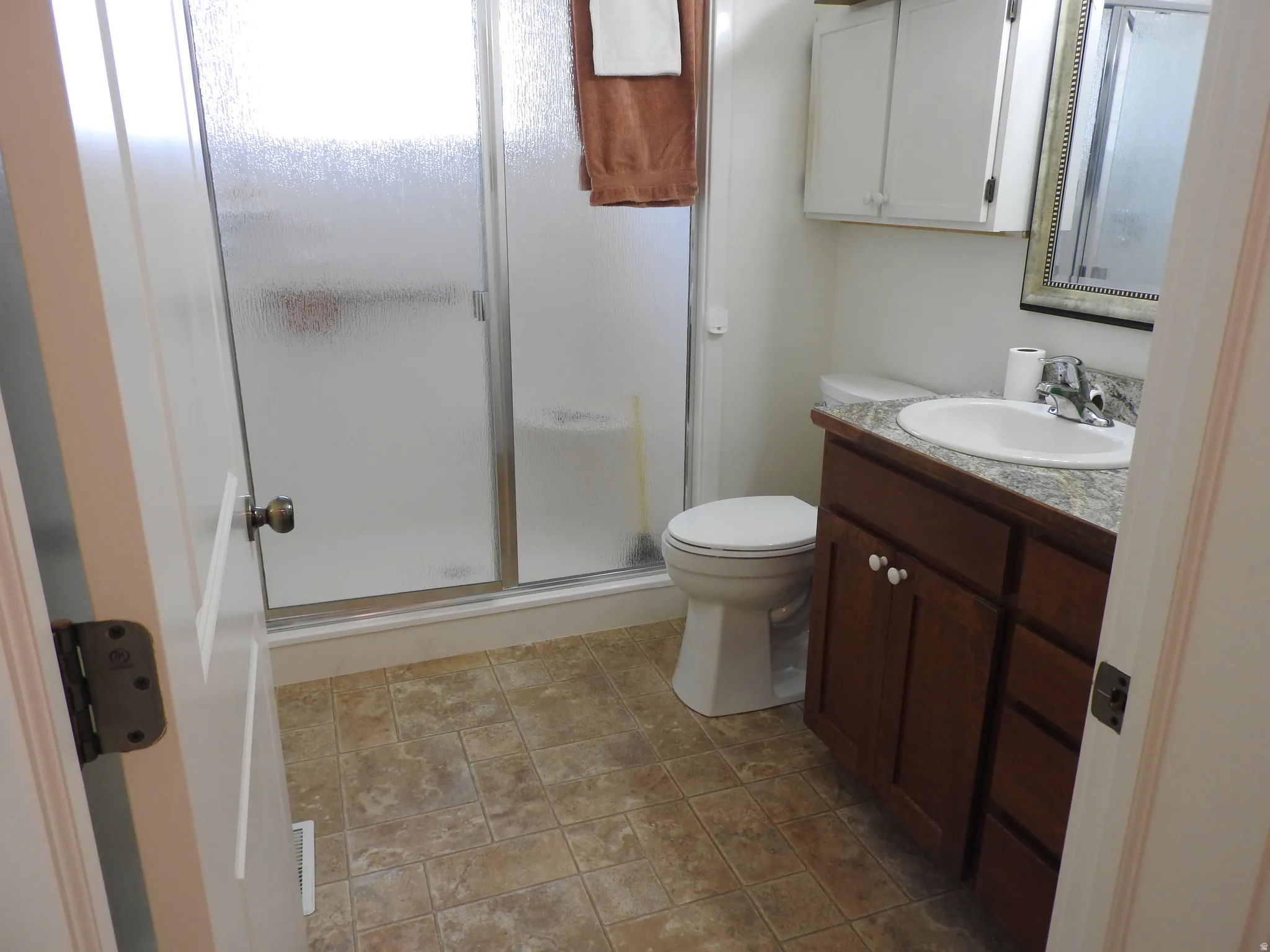 Bathroom with vanity and a stall shower