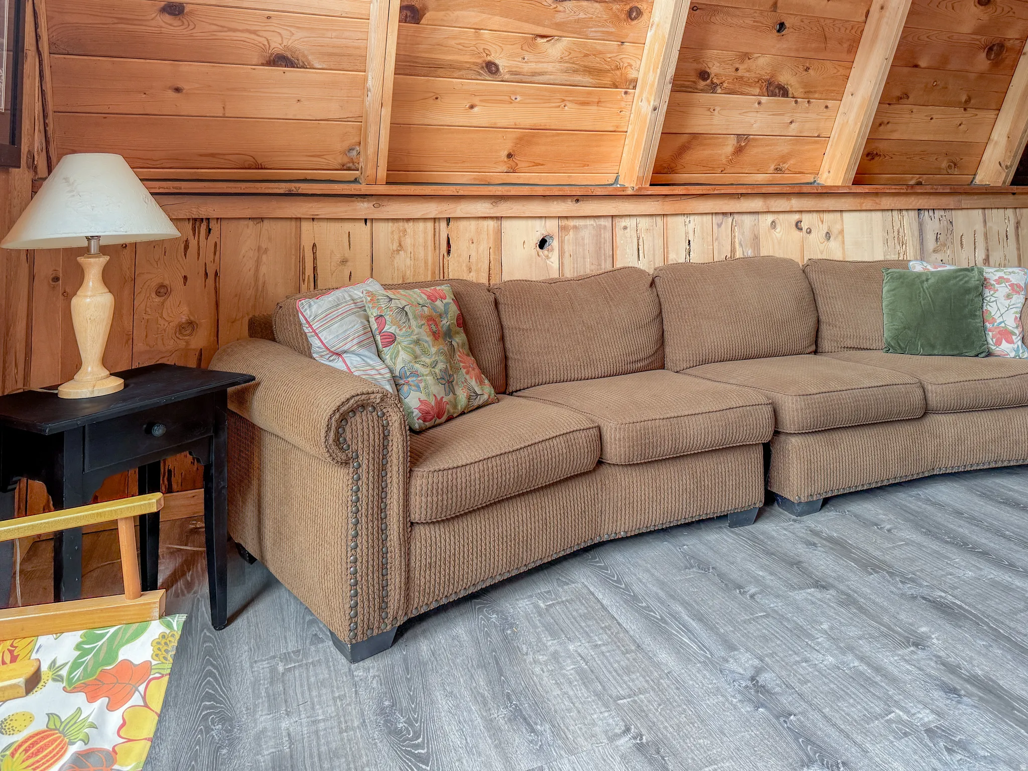 Living room with wood finished floors and wood walls
