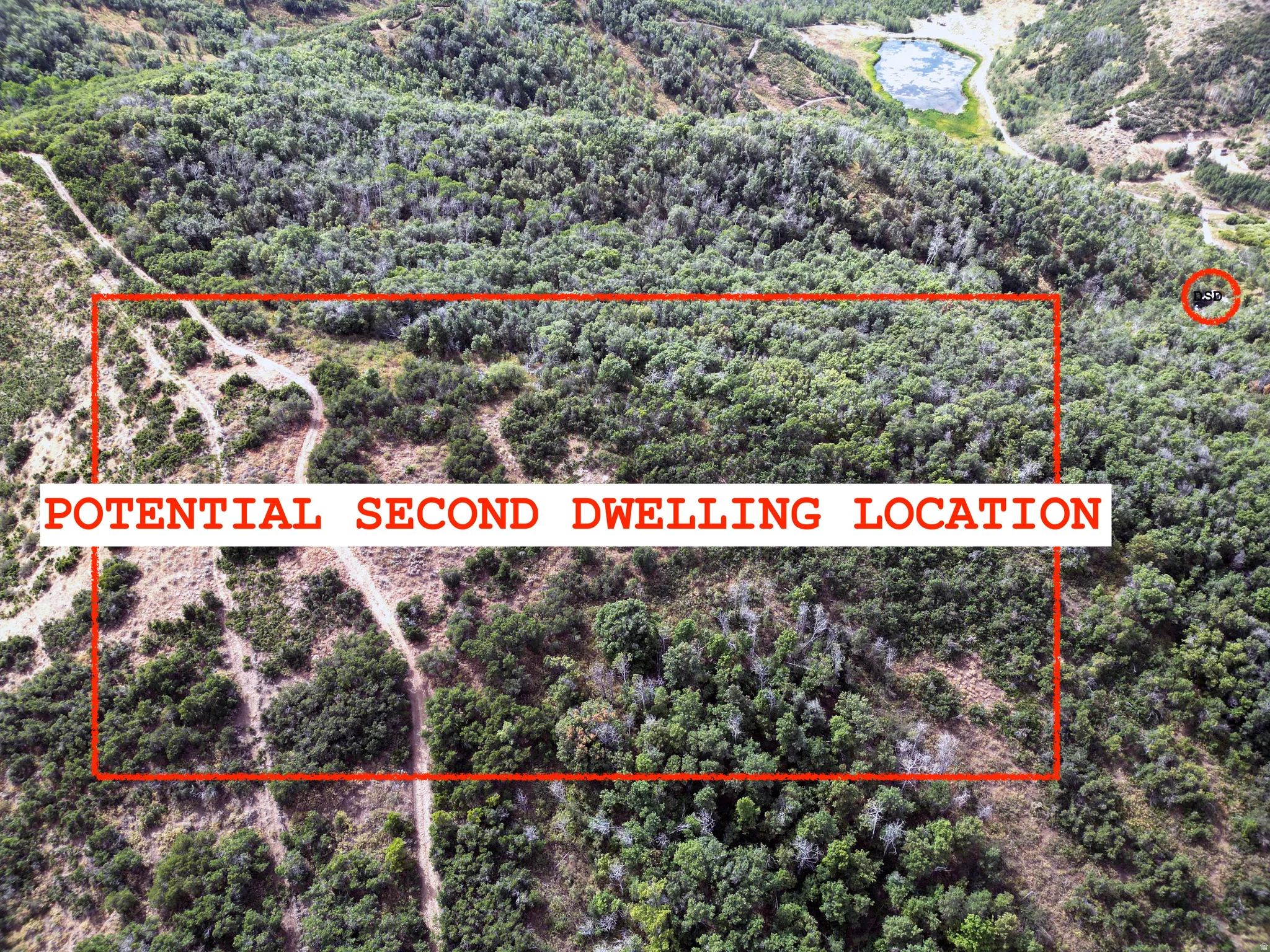 View of property location with property parcel outlined and a heavily wooded area