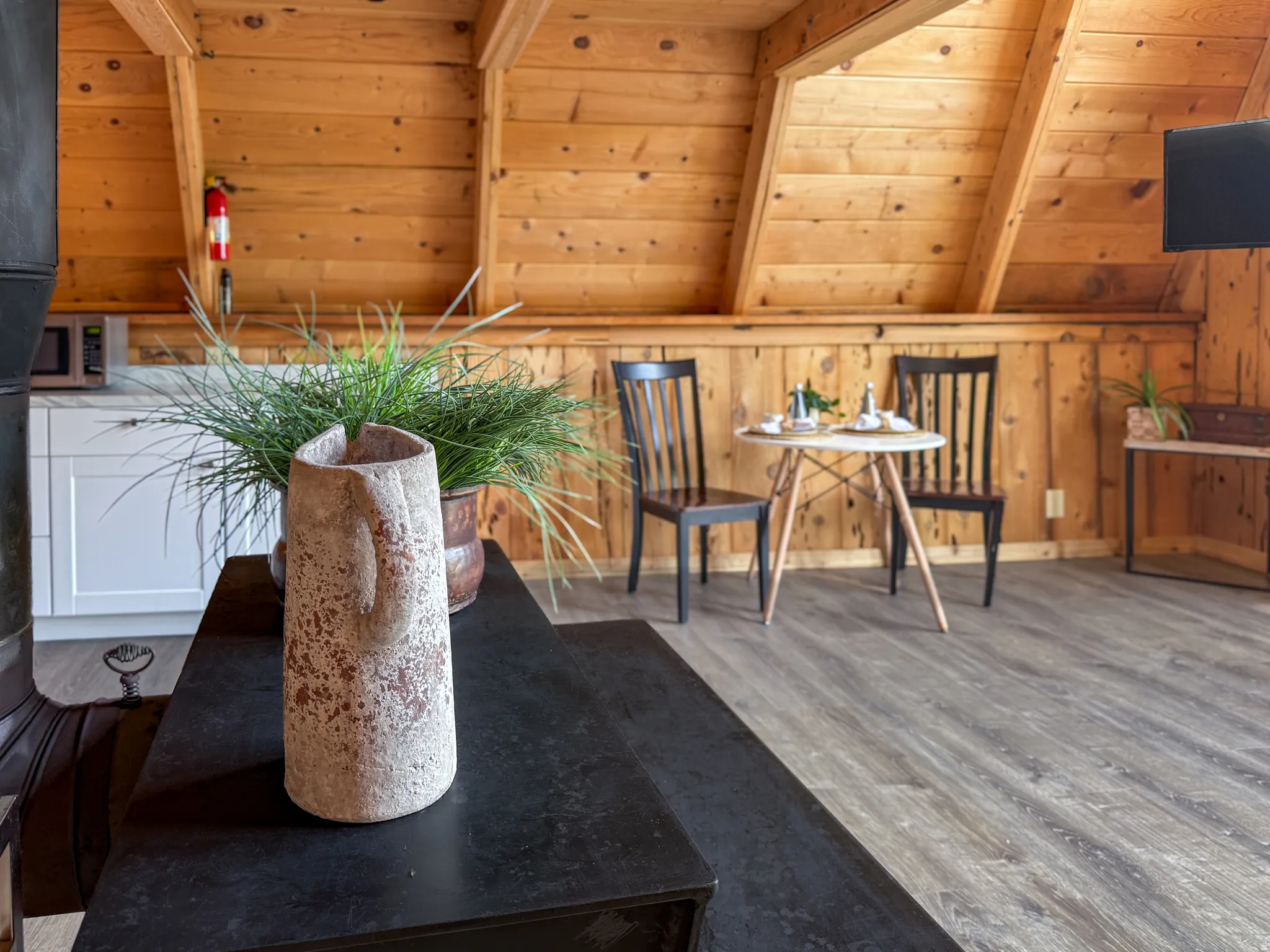 Sitting room with wood finished floors, wood walls, and wooden ceiling