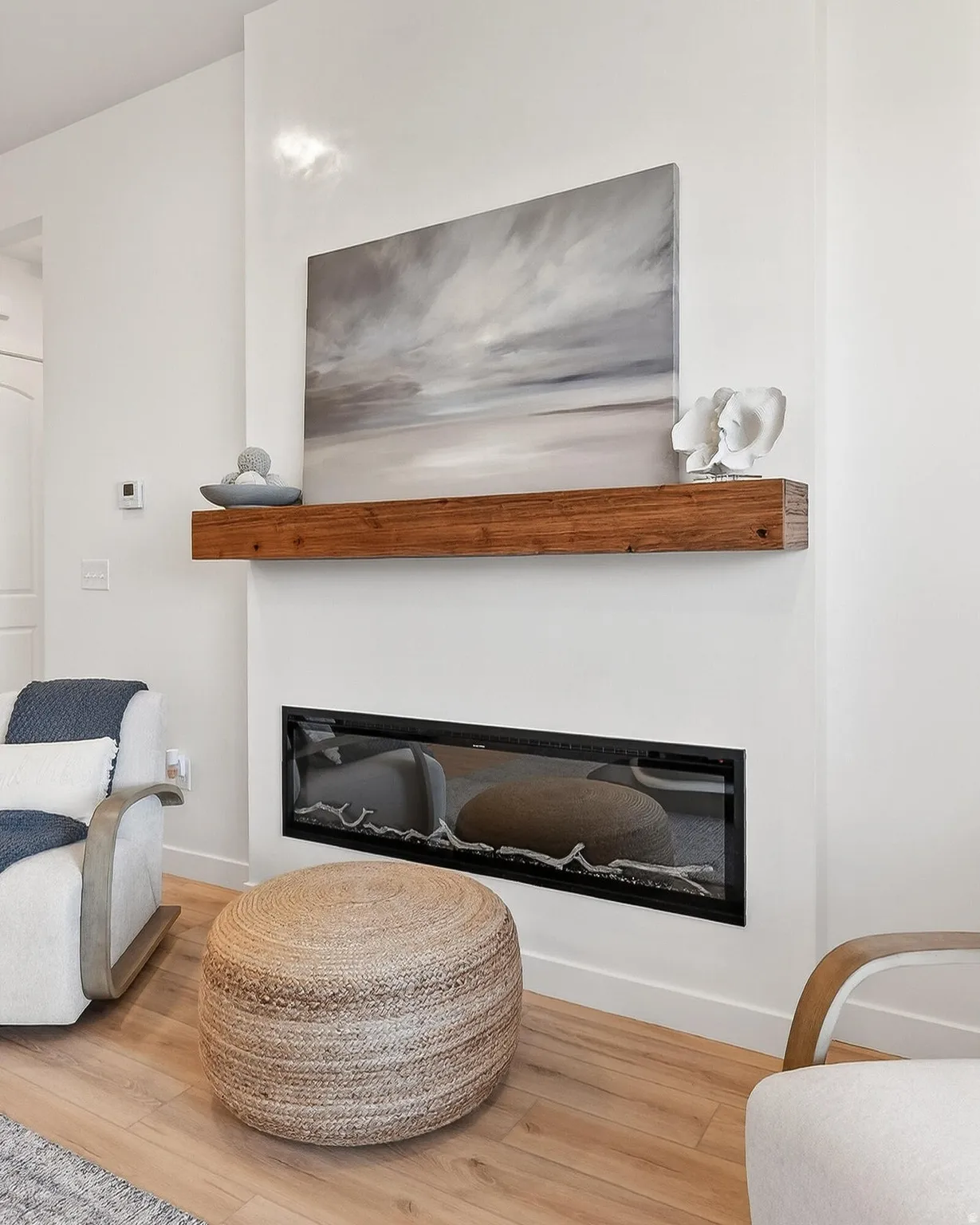 Detailed view of a glass covered fireplace and wood finished floors