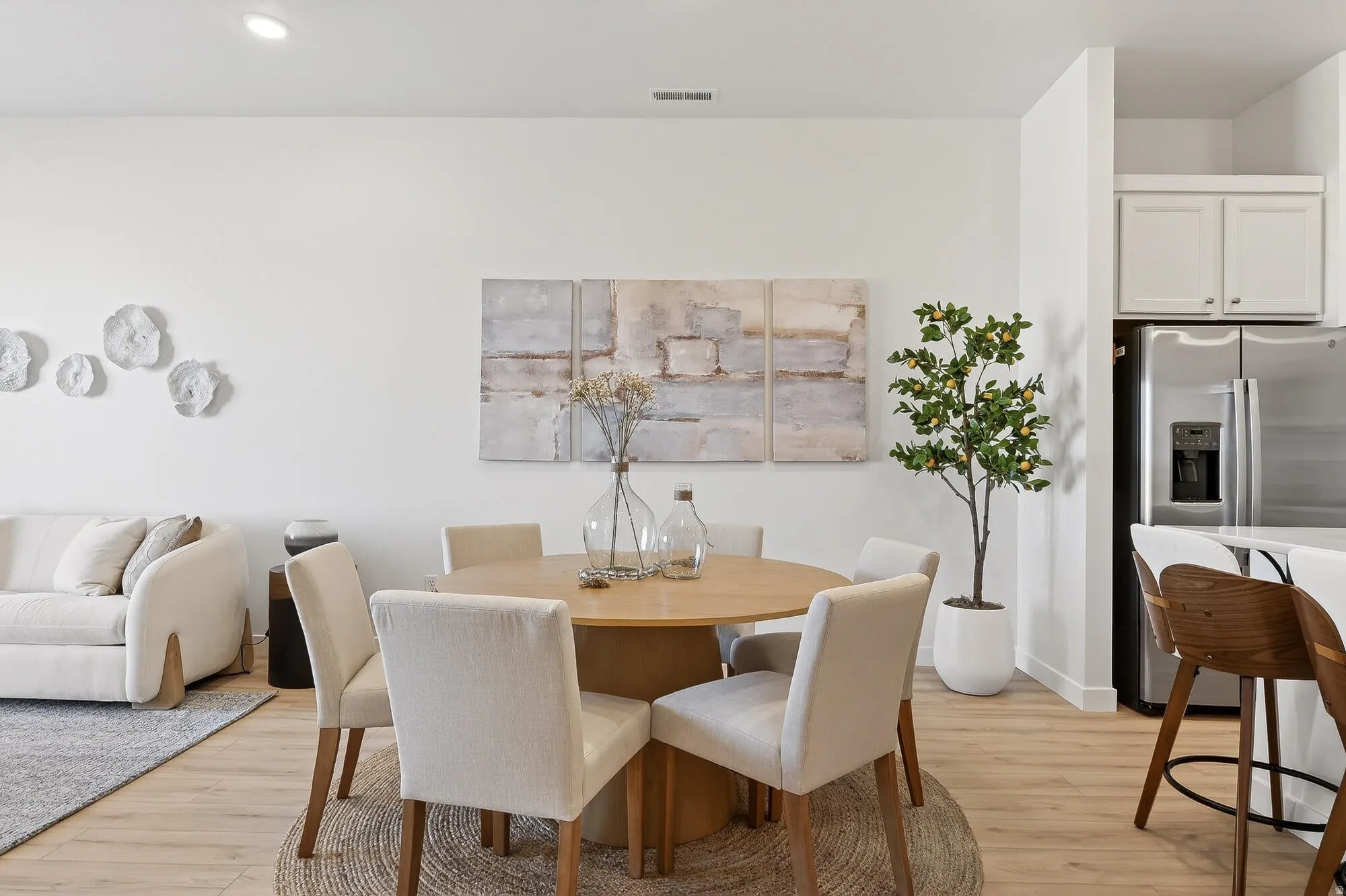 Dining room with light wood-type flooring and recessed lighting