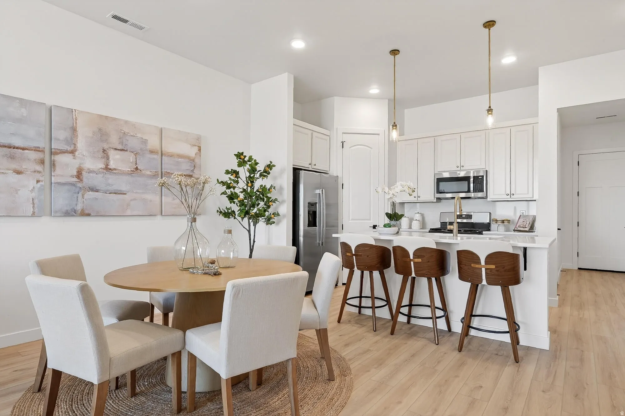 Dining space featuring light wood finished floors and recessed lighting