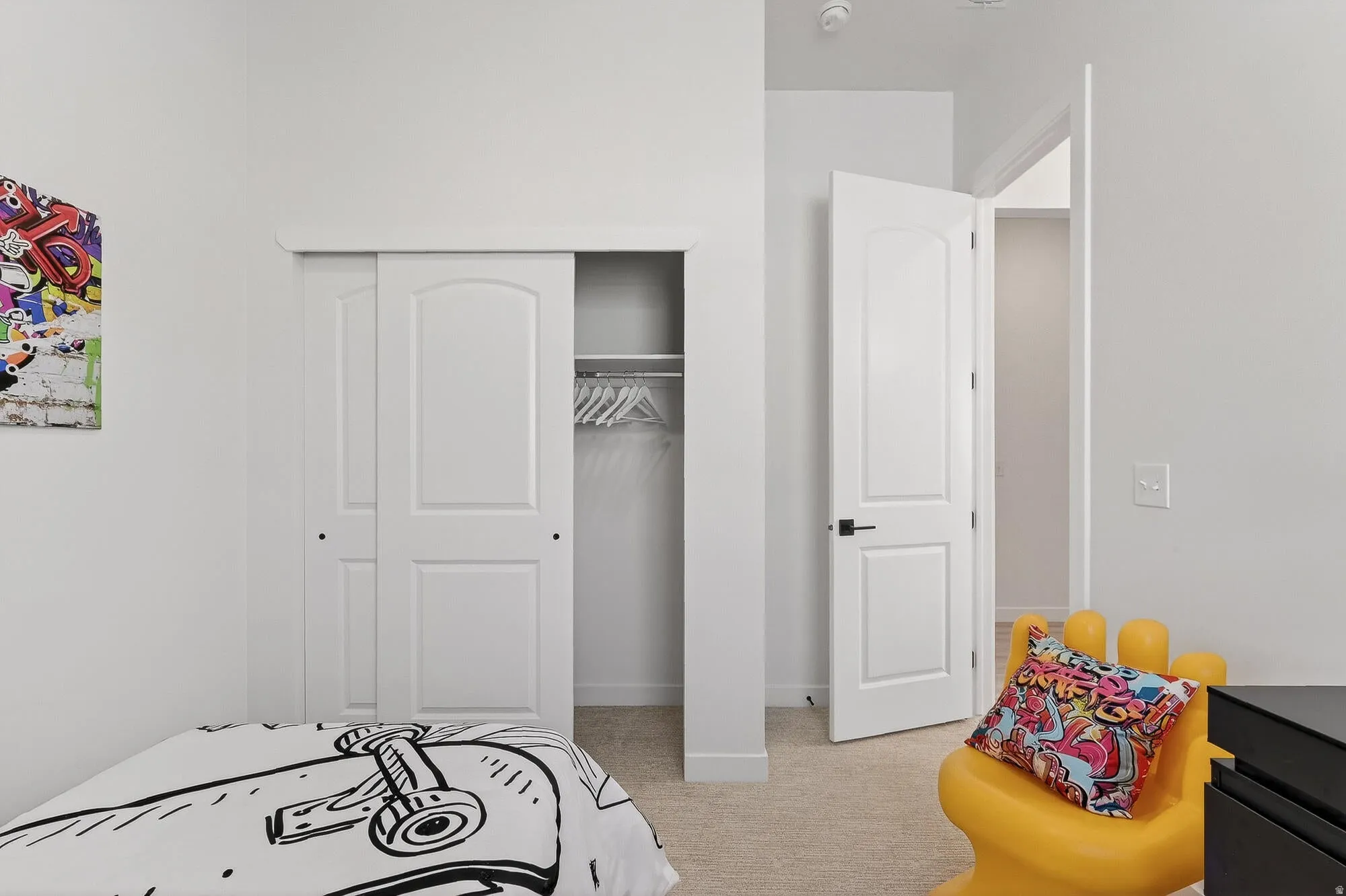 Bedroom featuring light colored carpet and a closet