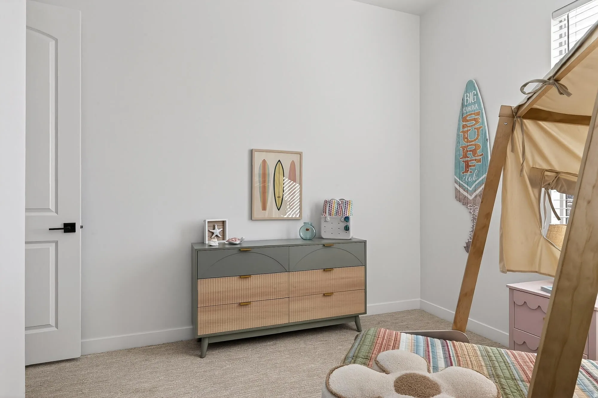 Bedroom featuring light carpet and baseboards