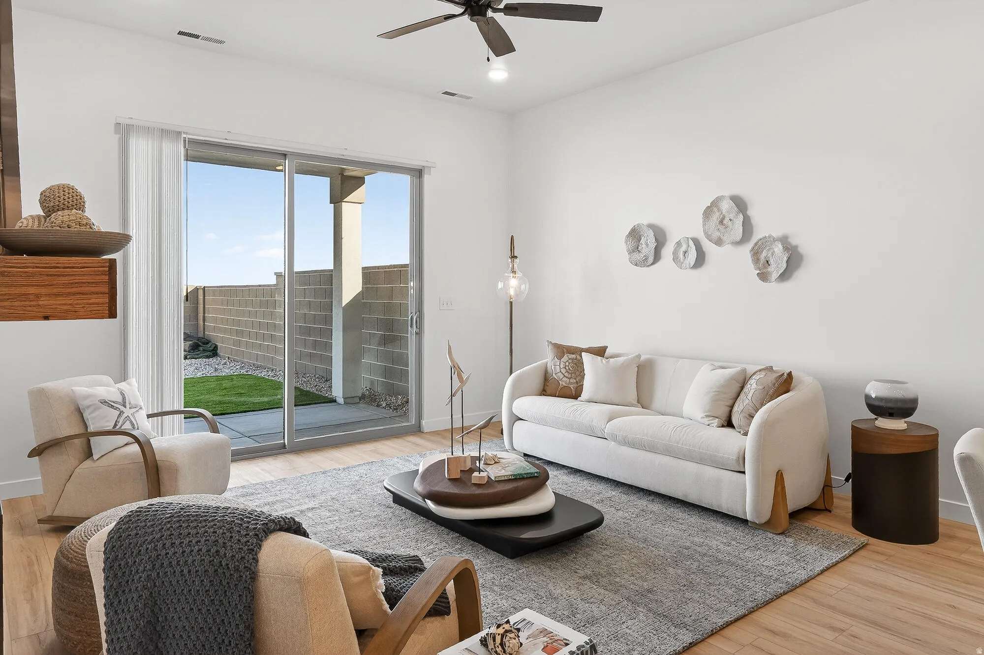 Living room featuring light wood finished floors, ceiling fan, and recessed lighting