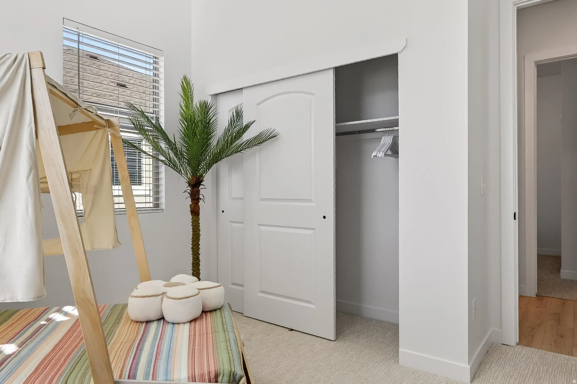 Bedroom with a closet and light carpet
