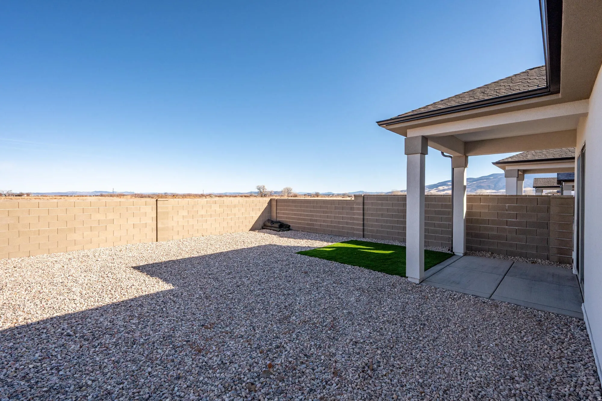 Fenced backyard with a patio area
