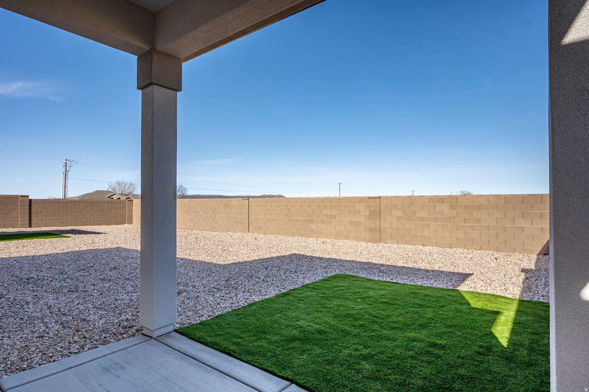 Fenced backyard with a patio