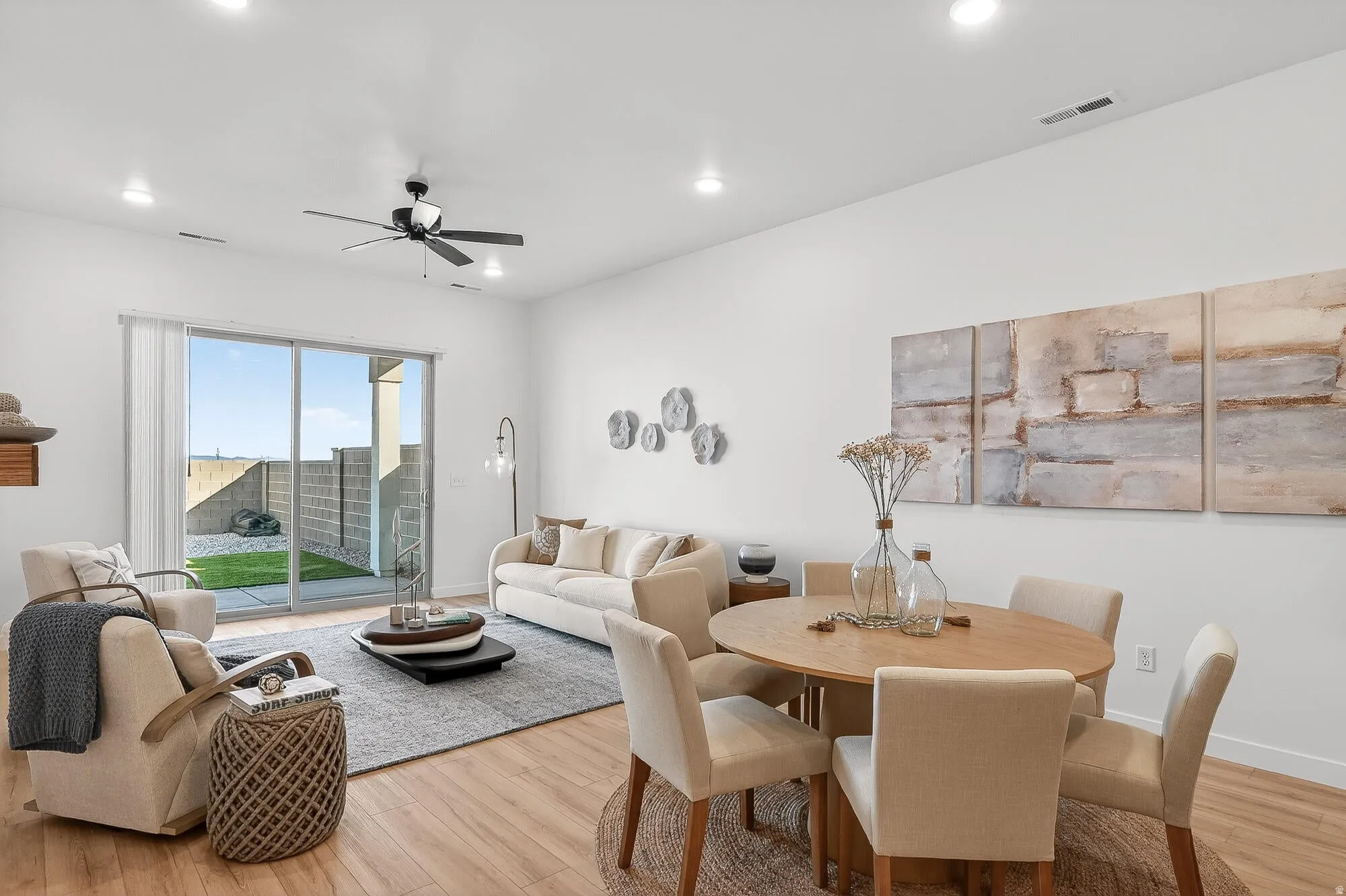 Dining room with light wood-type flooring, ceiling fan, and recessed lighting