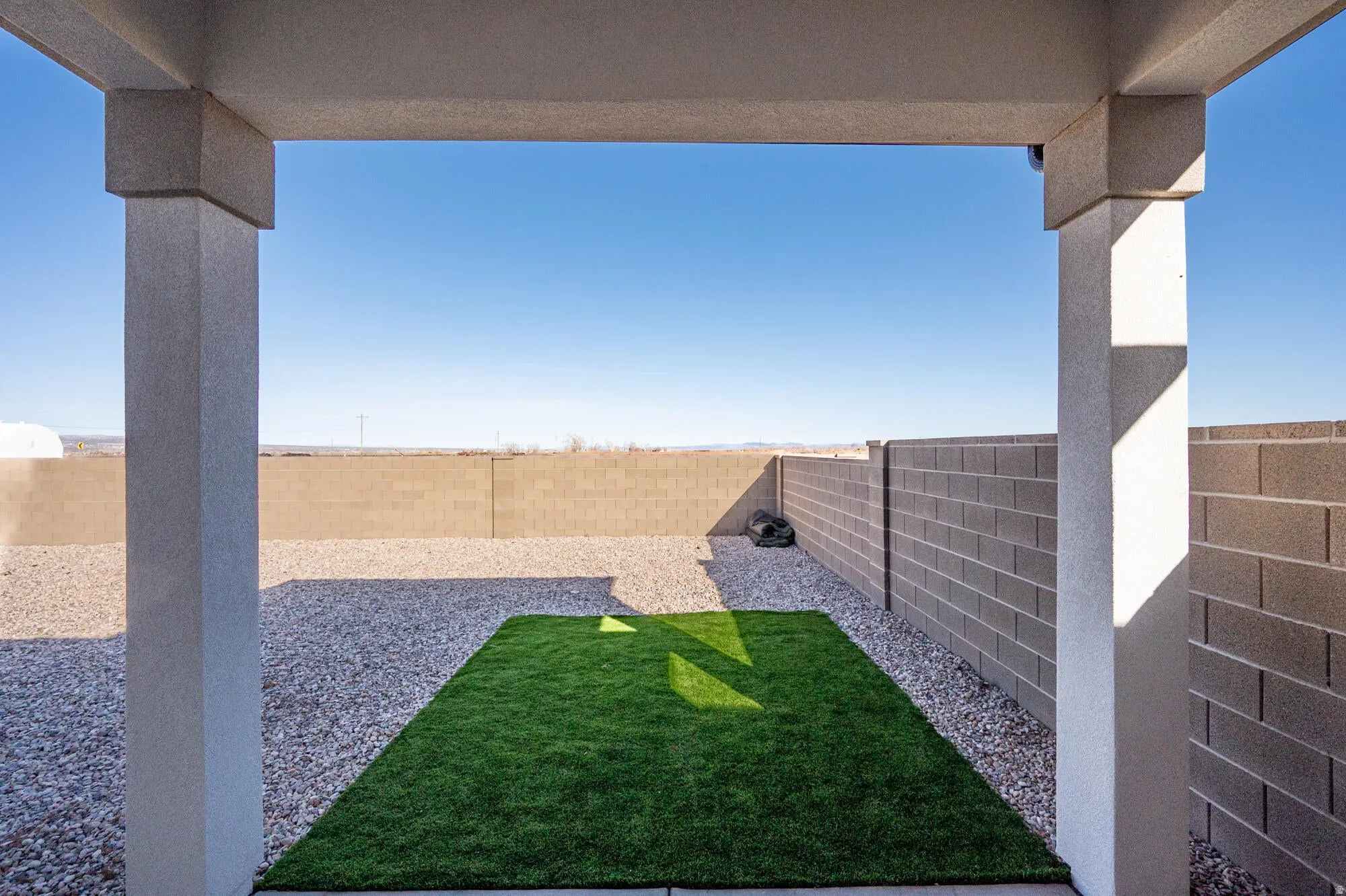 Fenced backyard with a patio area