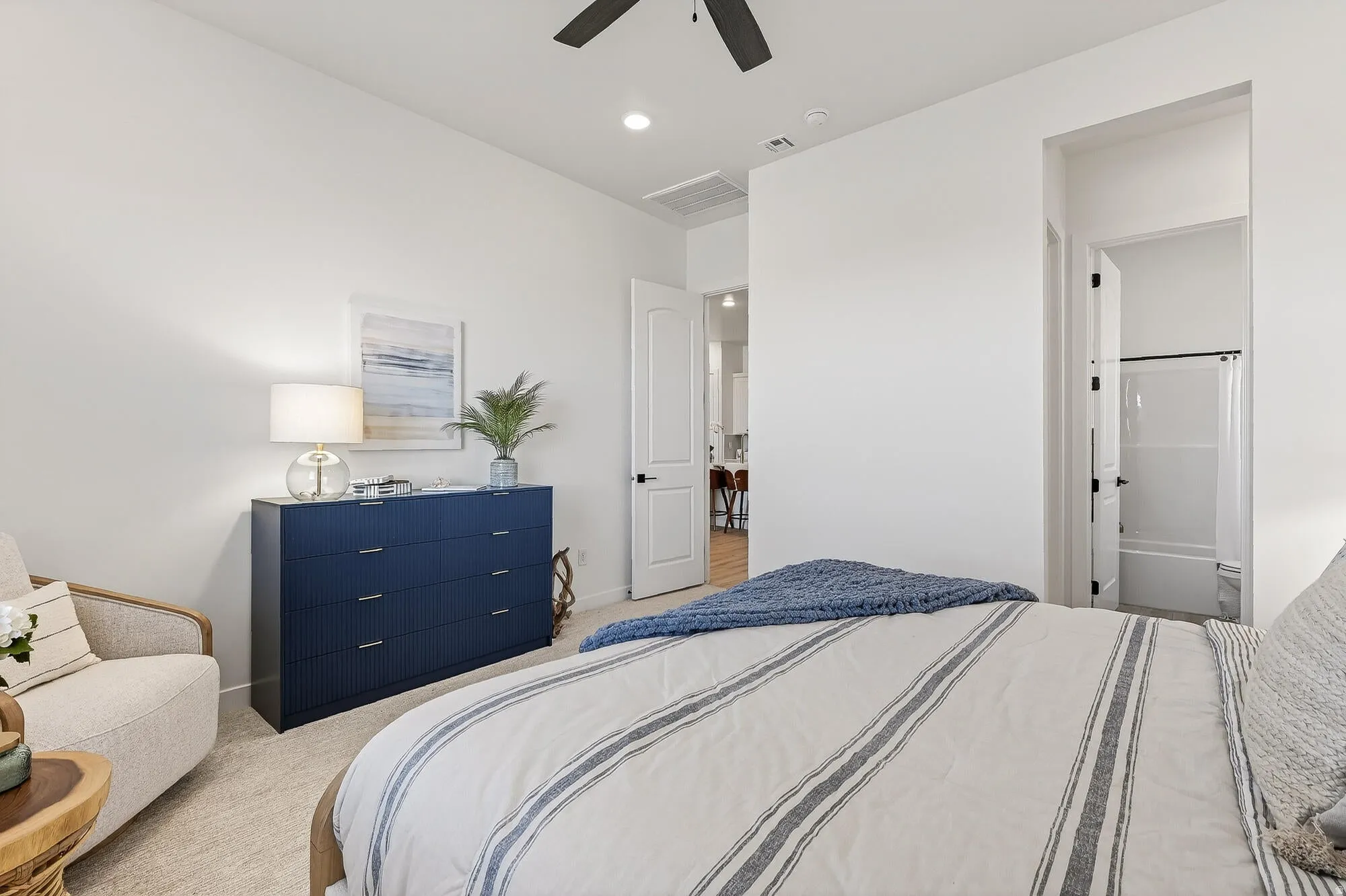 Bedroom featuring light colored carpet, a ceiling fan, connected bathroom, and recessed lighting