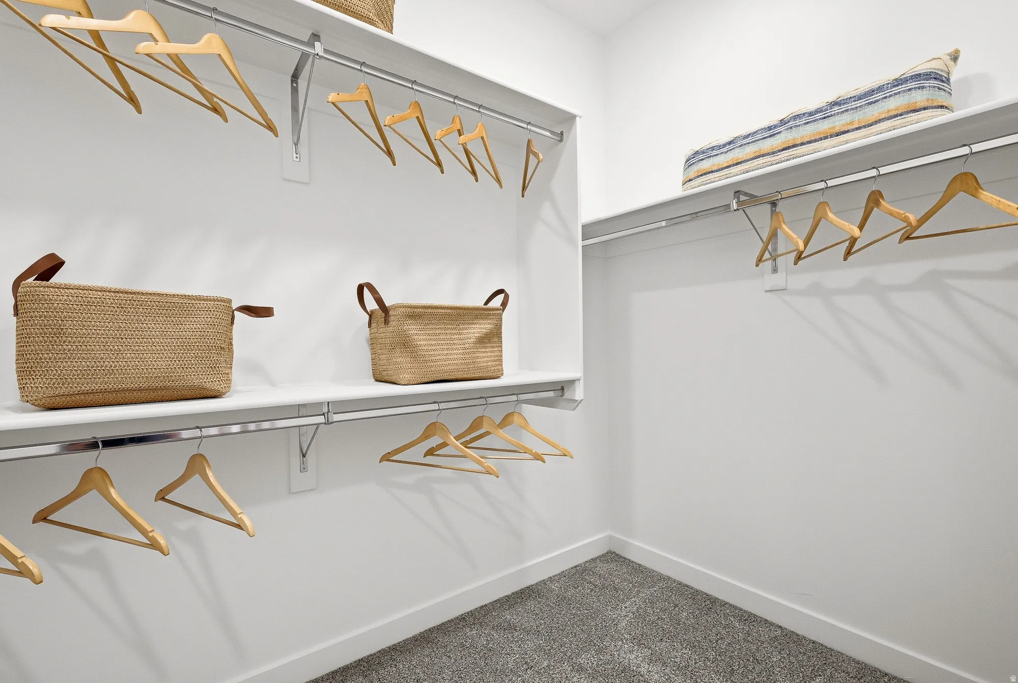 Walk in closet featuring dark carpet