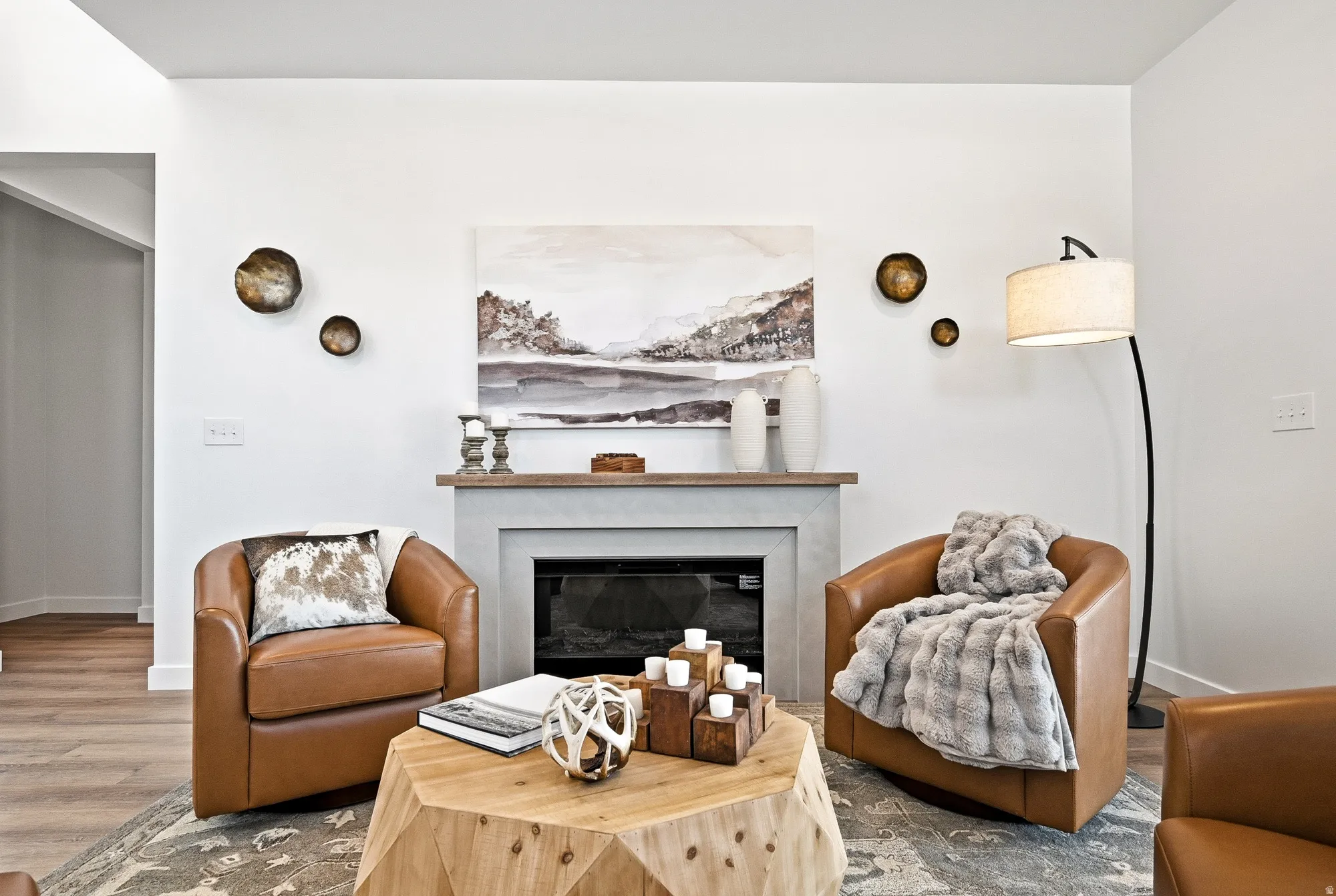 Living area with a glass covered fireplace and wood finished floors