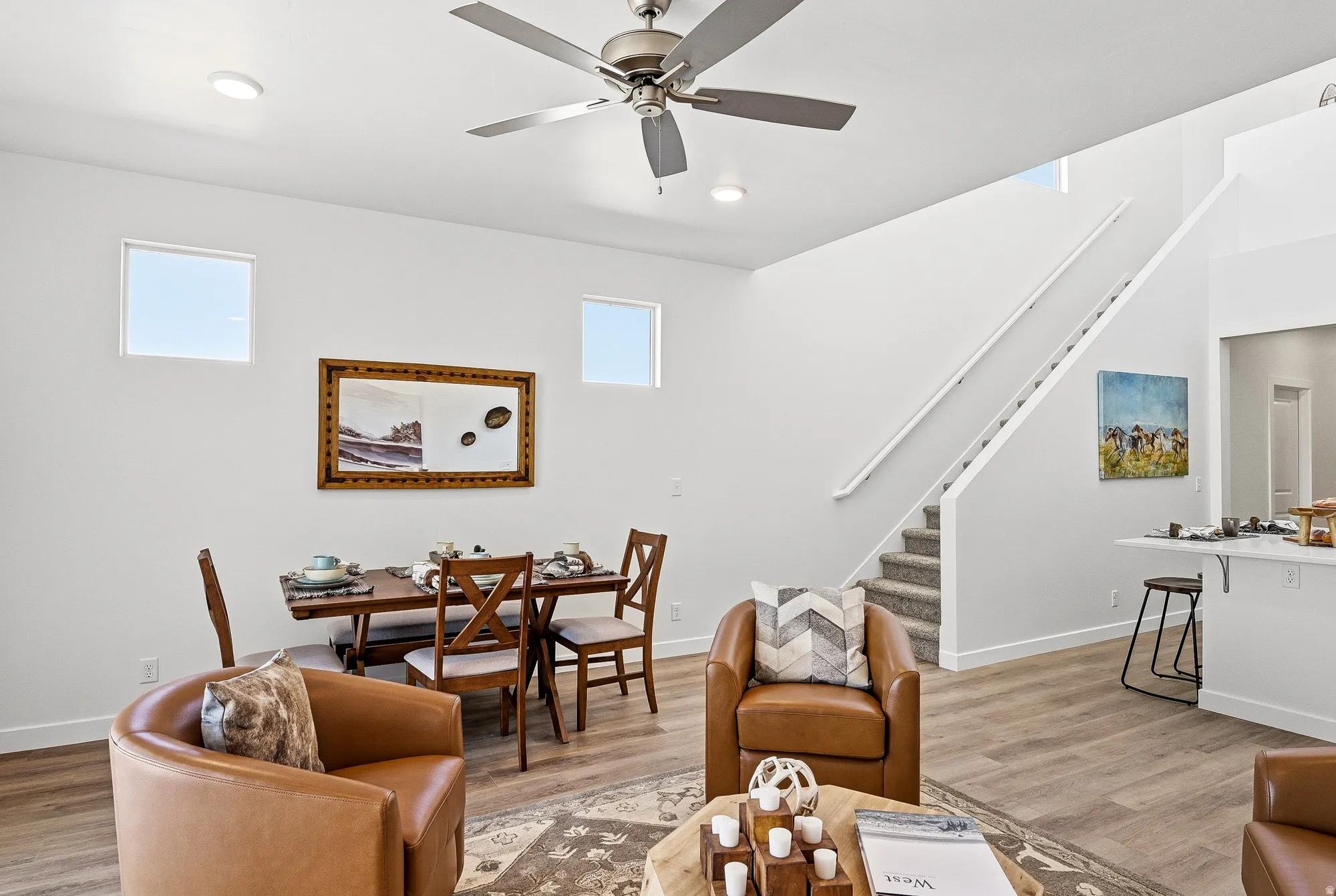 Living room featuring light wood-type flooring and ceiling fan