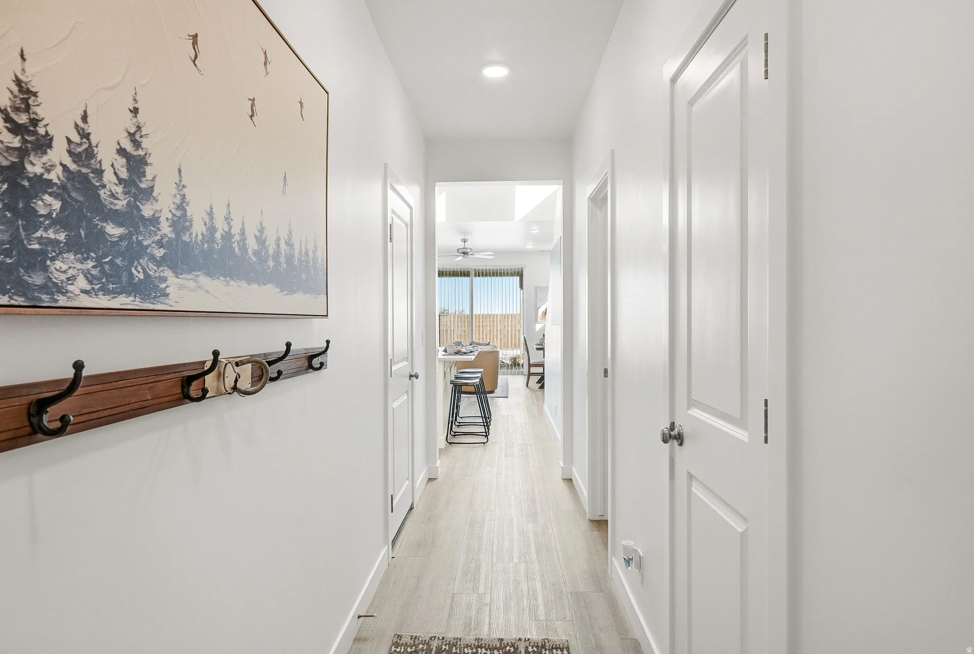 Hall with light wood-style floors and recessed lighting