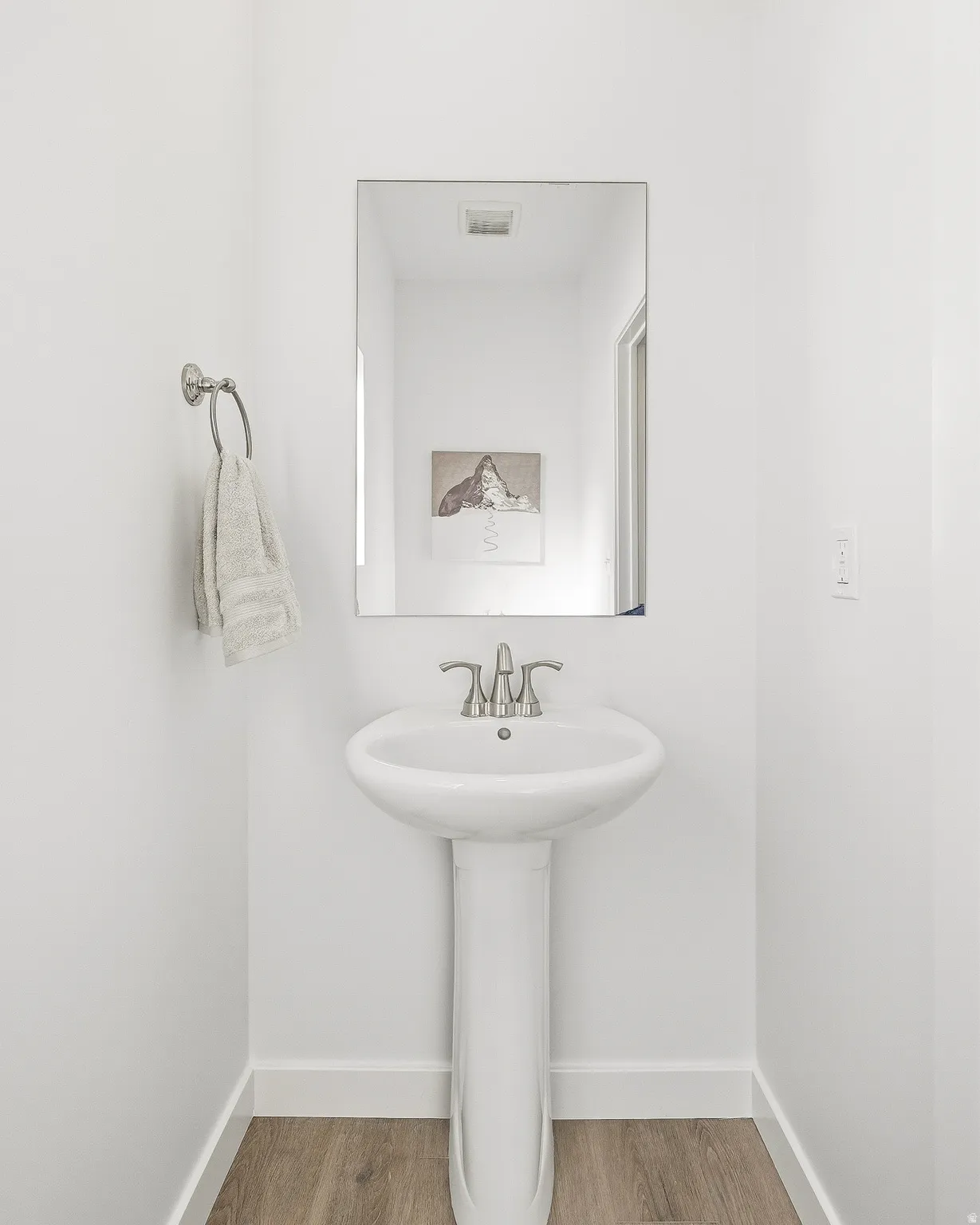 Bathroom featuring baseboards and wood finished floors