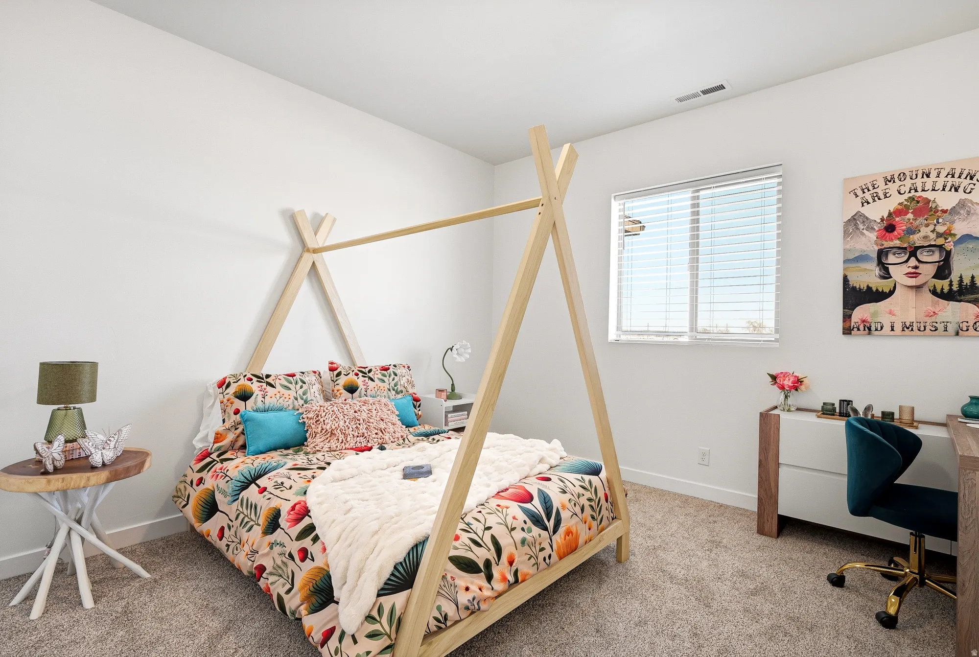 Bedroom with a desk and light colored carpet