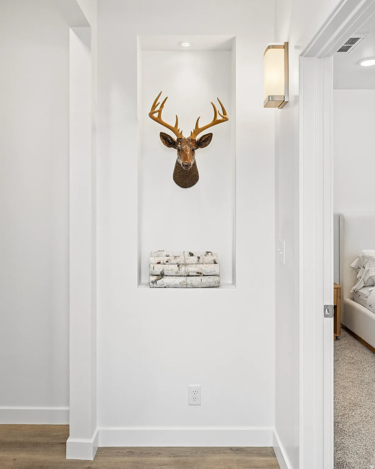 Detailed view of wood finished floors and recessed lighting