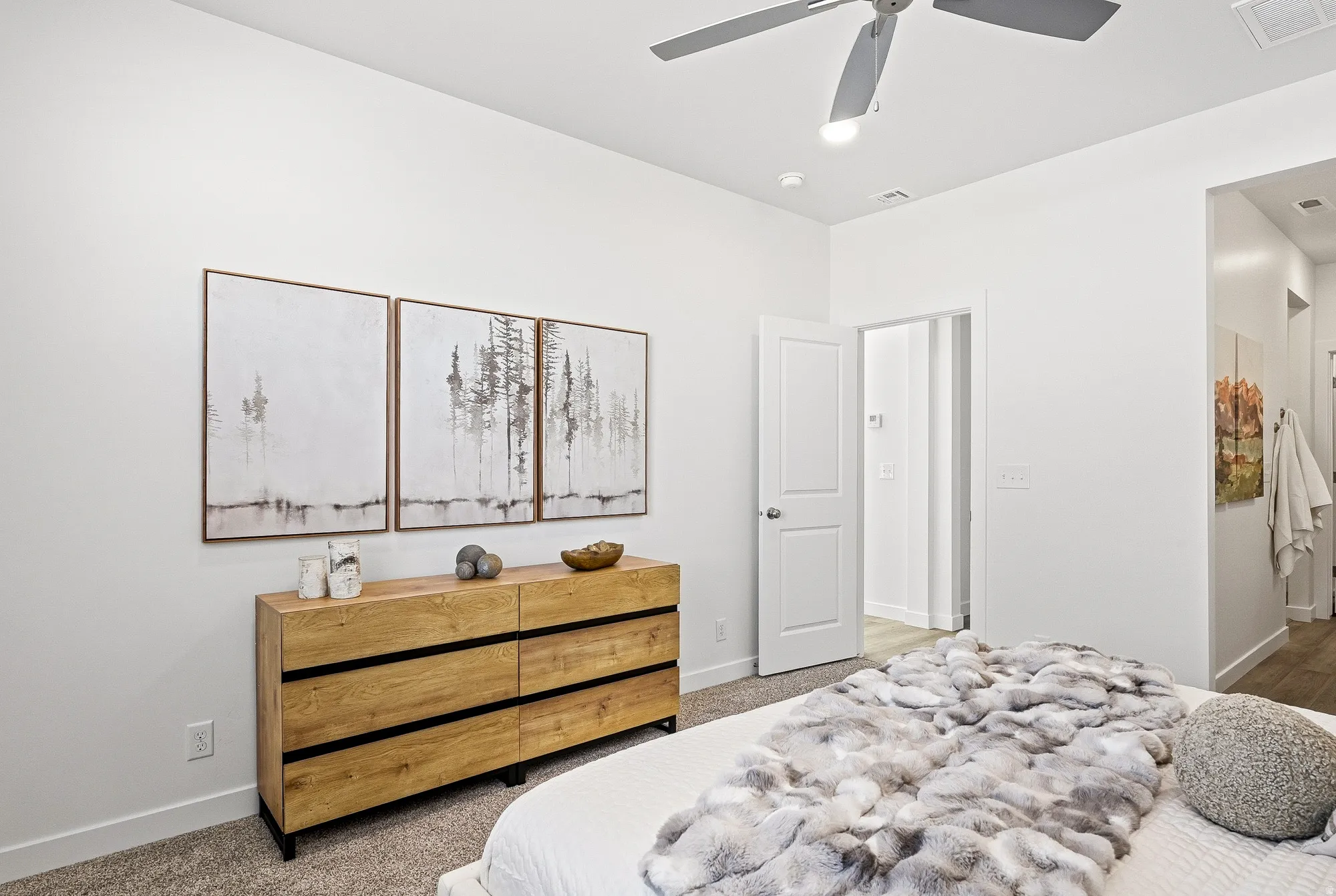 Carpeted bedroom featuring baseboards and a ceiling fan