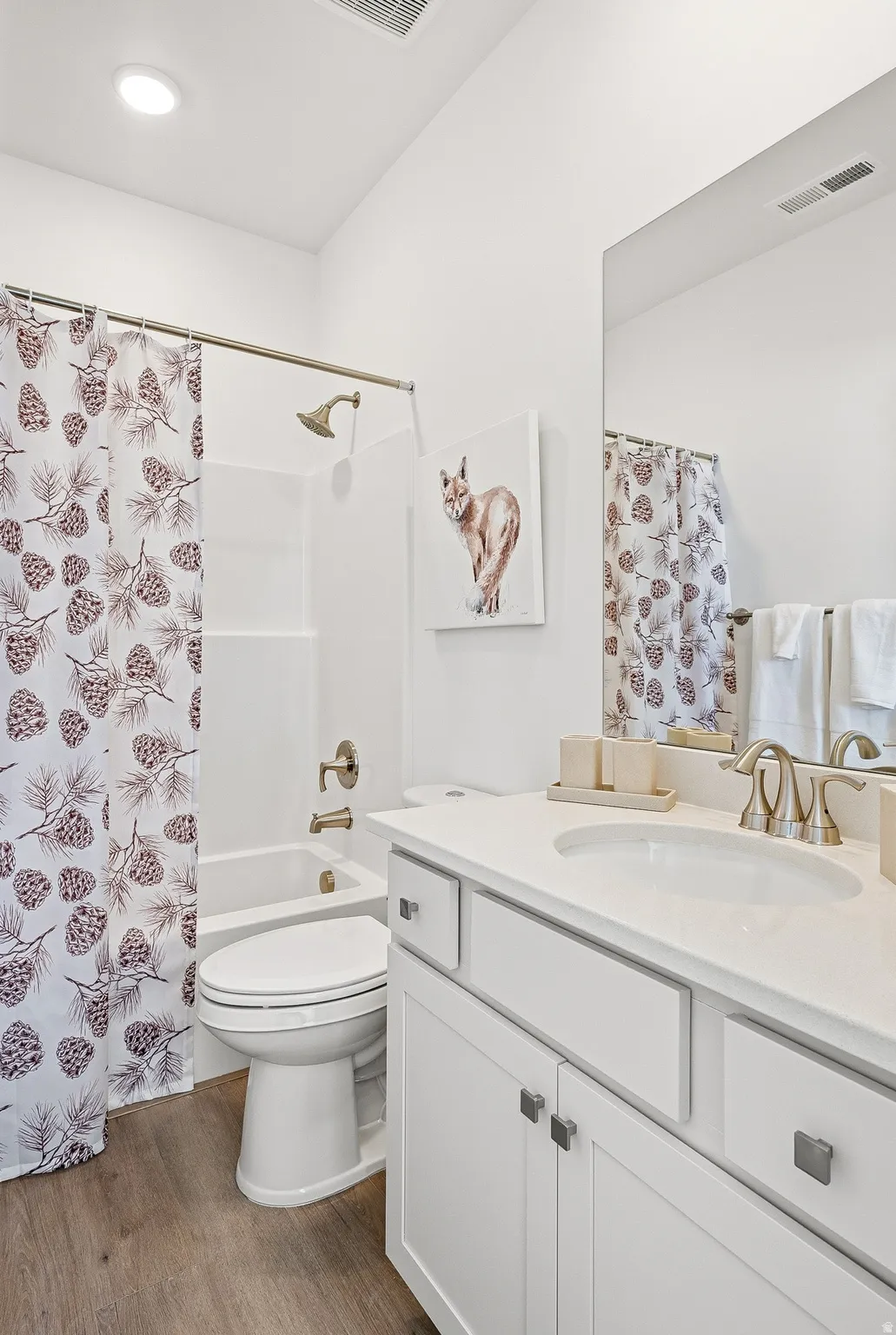 Full bathroom with vanity, dark wood finished floors, and shower / bath combination with curtain
