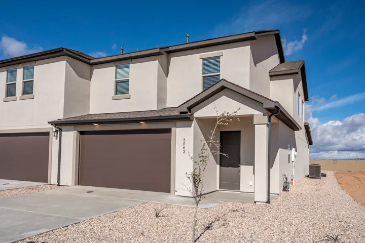 View of front of house with a garage, stucco siding, and concrete driveway