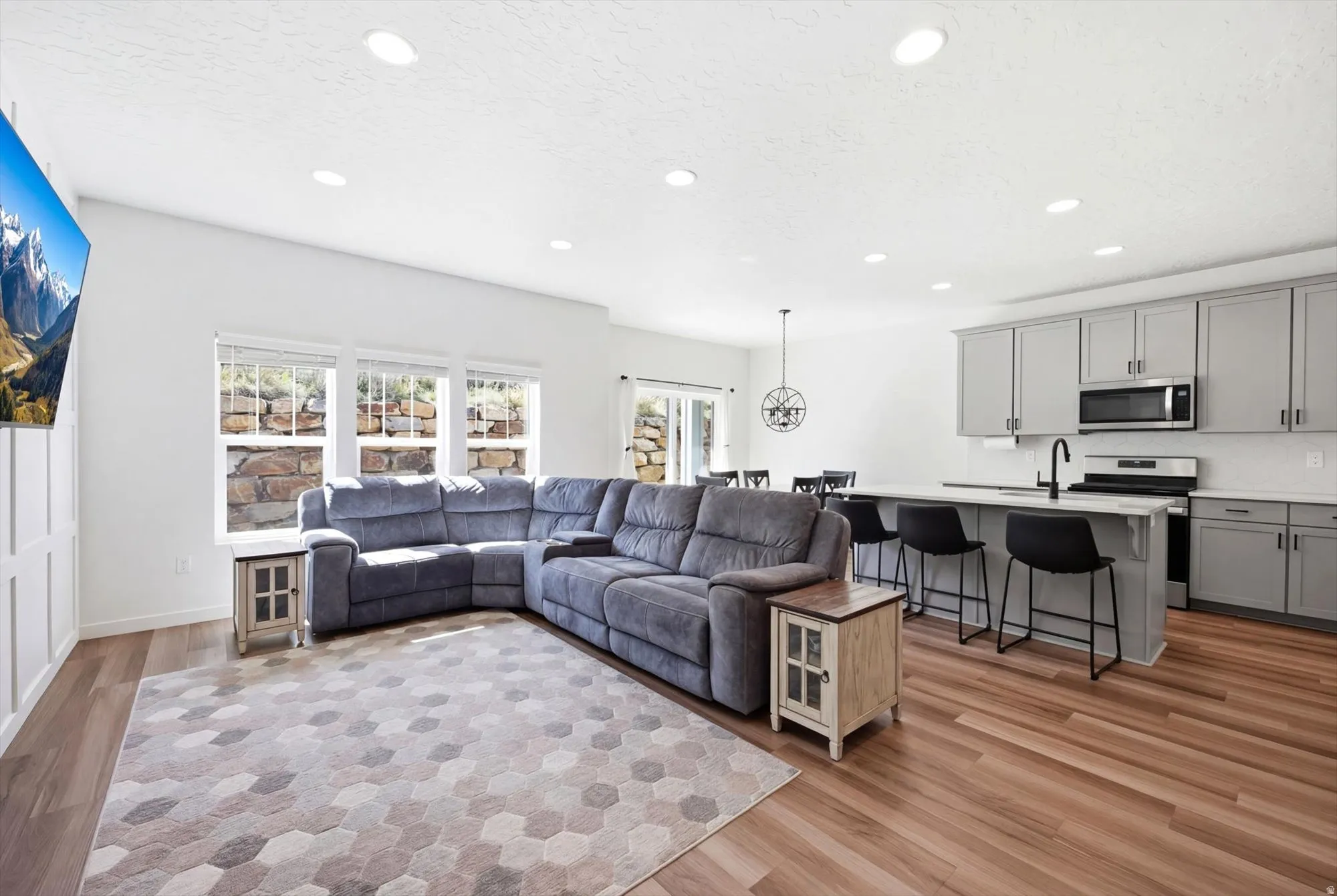 Living area featuring light wood finished floors and recessed lighting