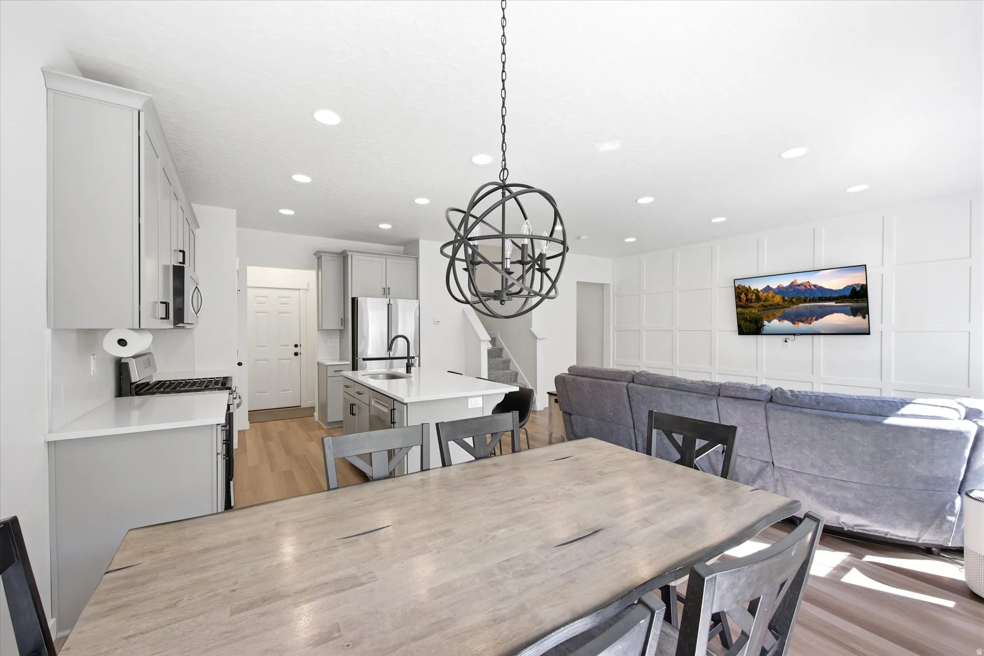 Dining area featuring light wood-type flooring and a chandelier