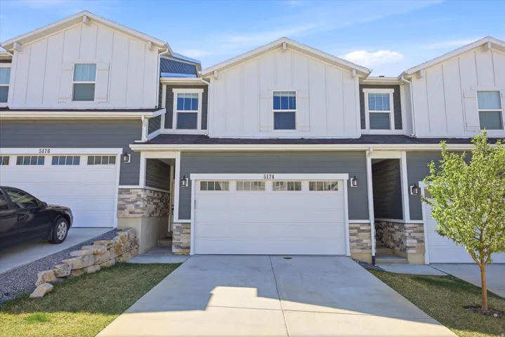 Craftsman-style house featuring board and batten siding, stone siding, and an attached garage