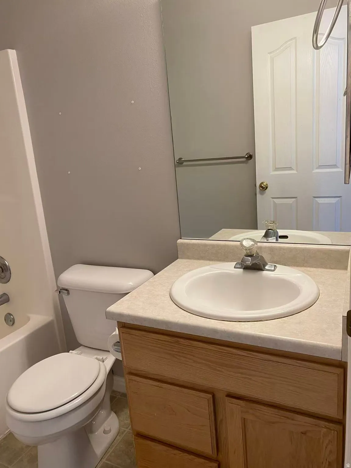 Bathroom featuring vanity, tub / shower combination, and light tile patterned floors